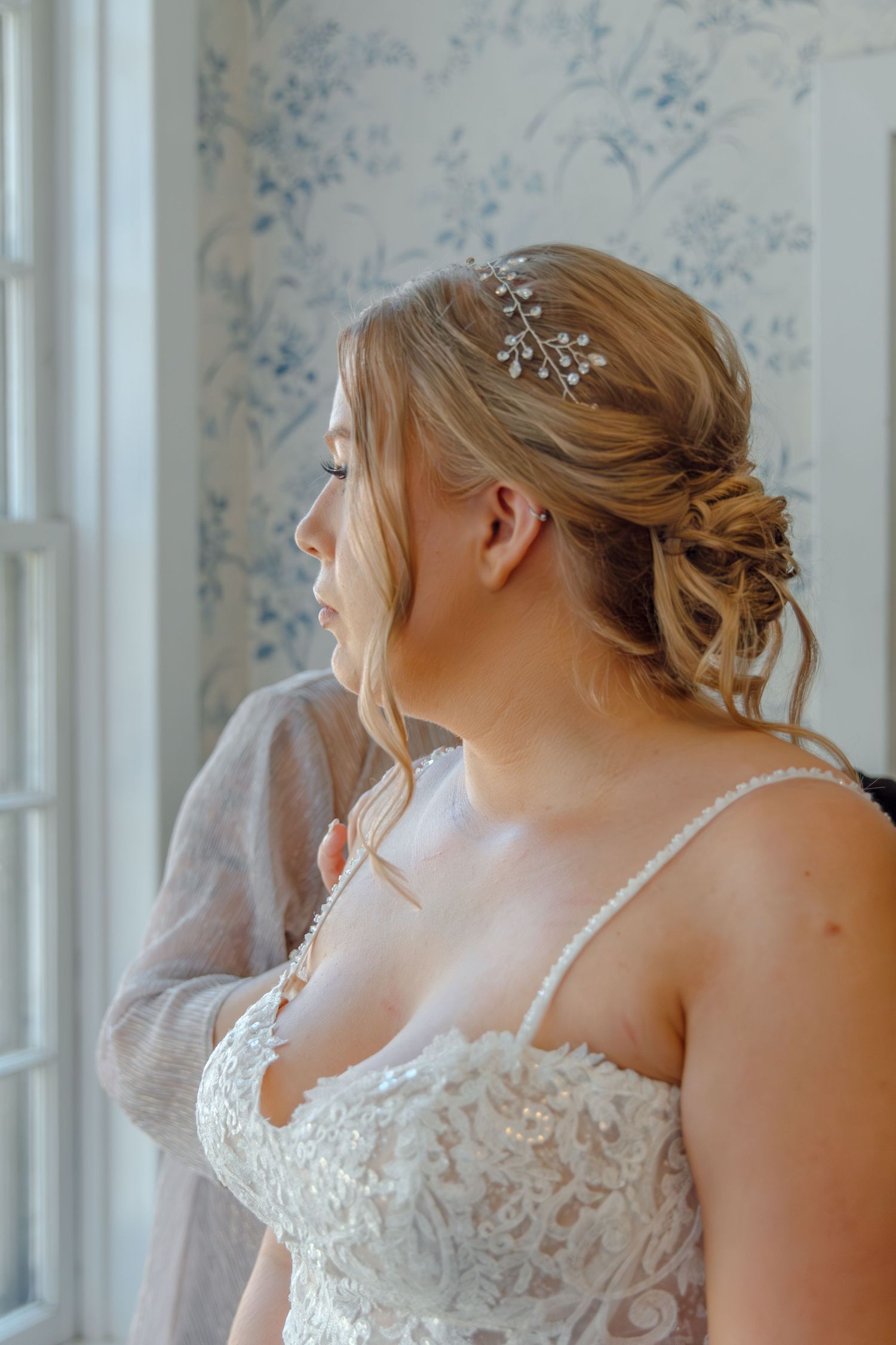 Close-up of bridal details showing lace dress and hair accessories.