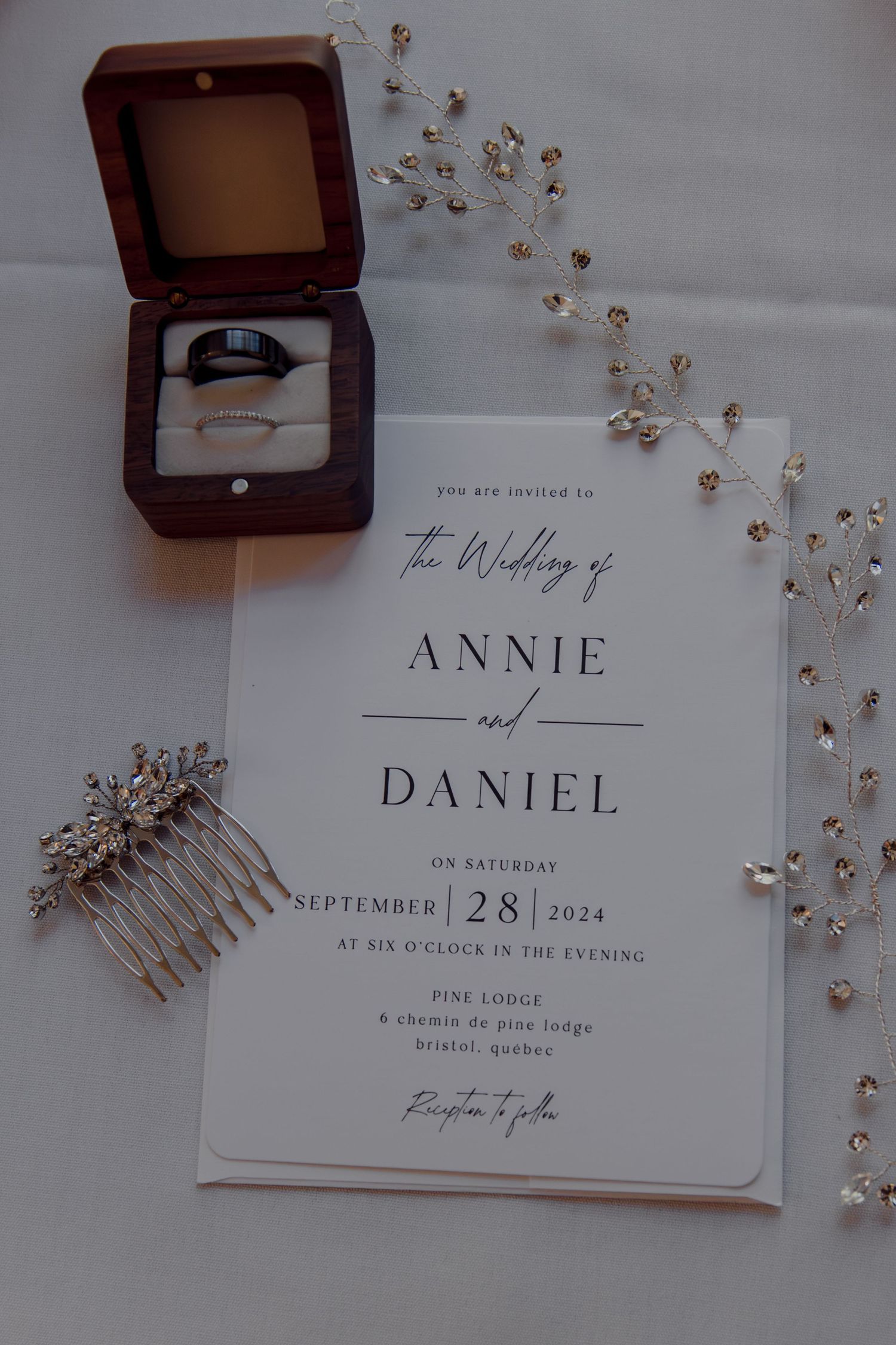 Wedding invitation suite with elegant typography and decorative hair accessories.