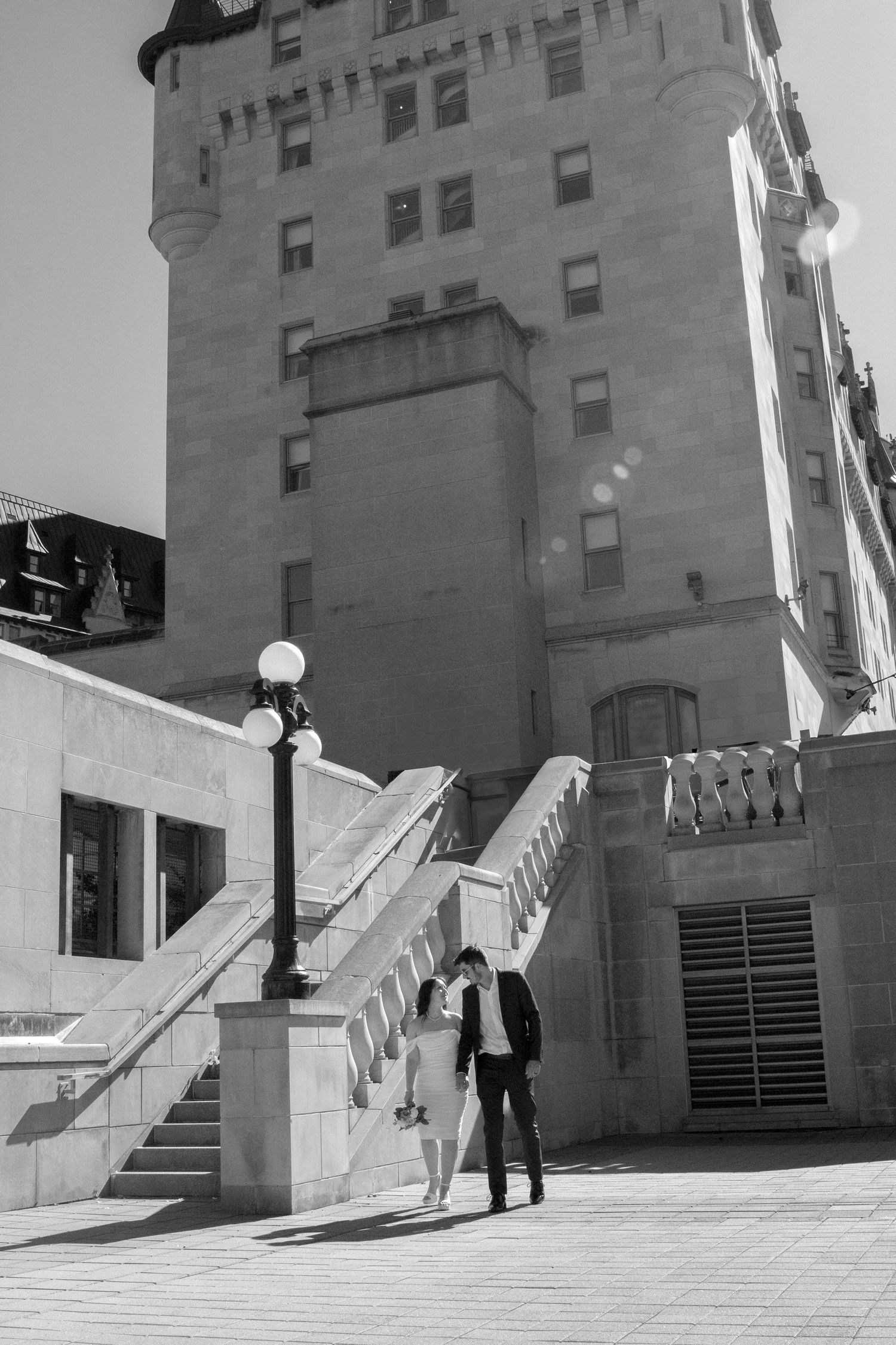 Architectural sequence showing people walking near stone steps and building entrance.