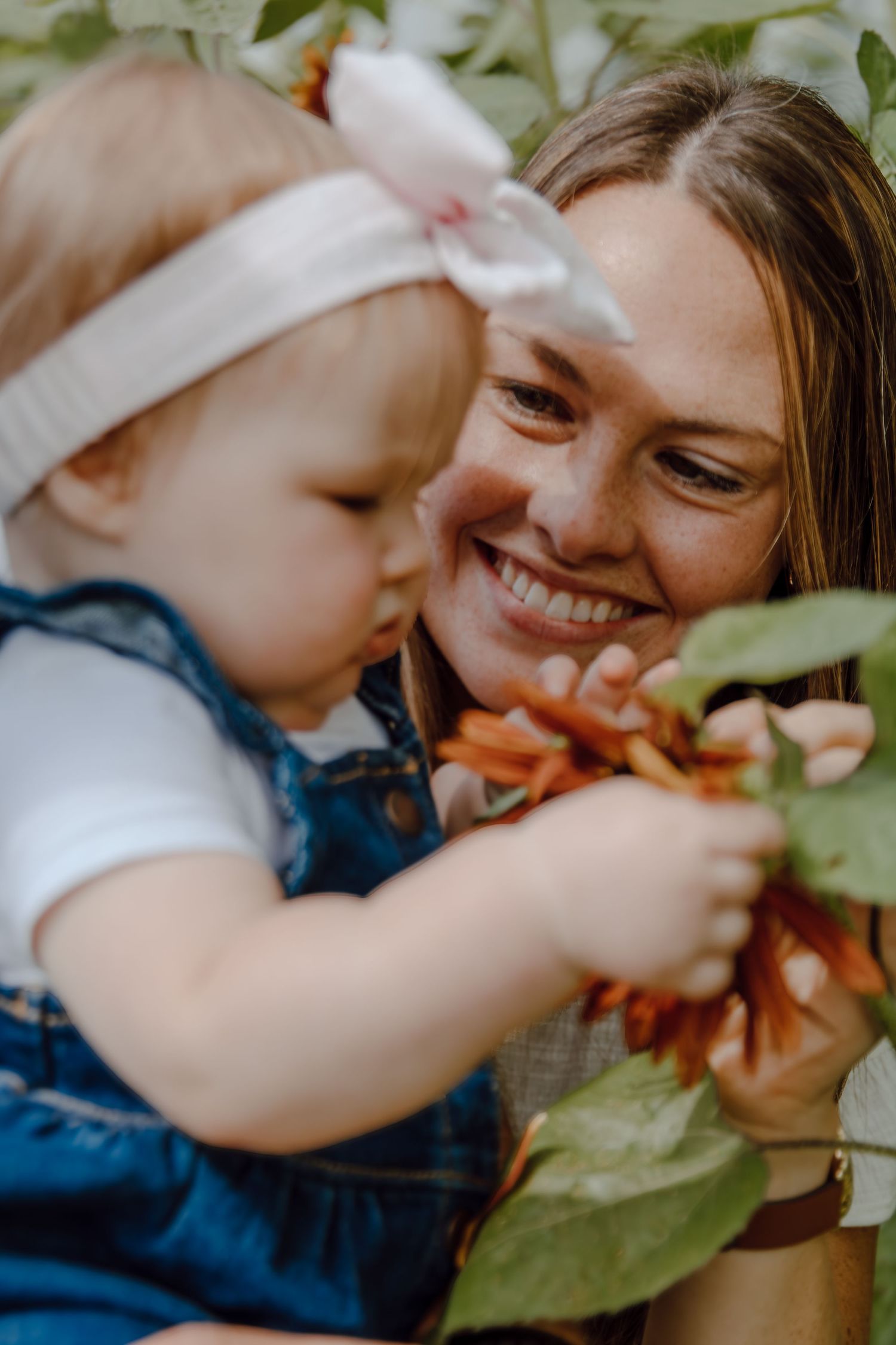 A tender moment shared among flowers in a garden setting.