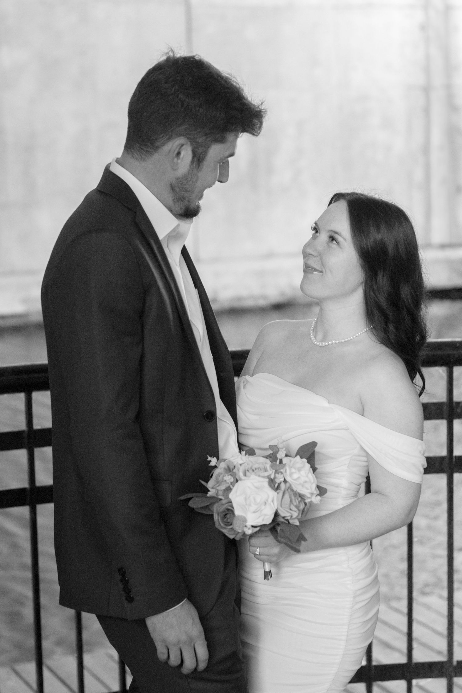 Candid black and white portraits of newlyweds sharing intimate moments.