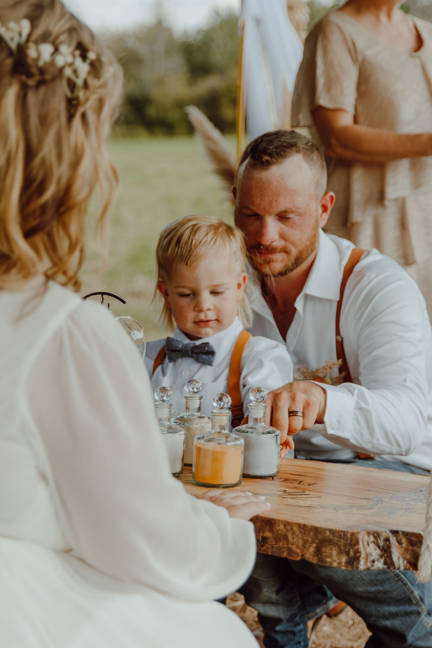 Intimate gathering around a rustic wooden table with casual outdoor dining setup.