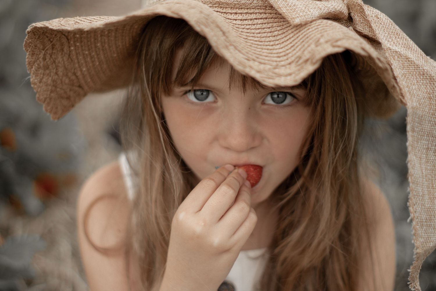 Portrait in straw hat with soft natural lighting.