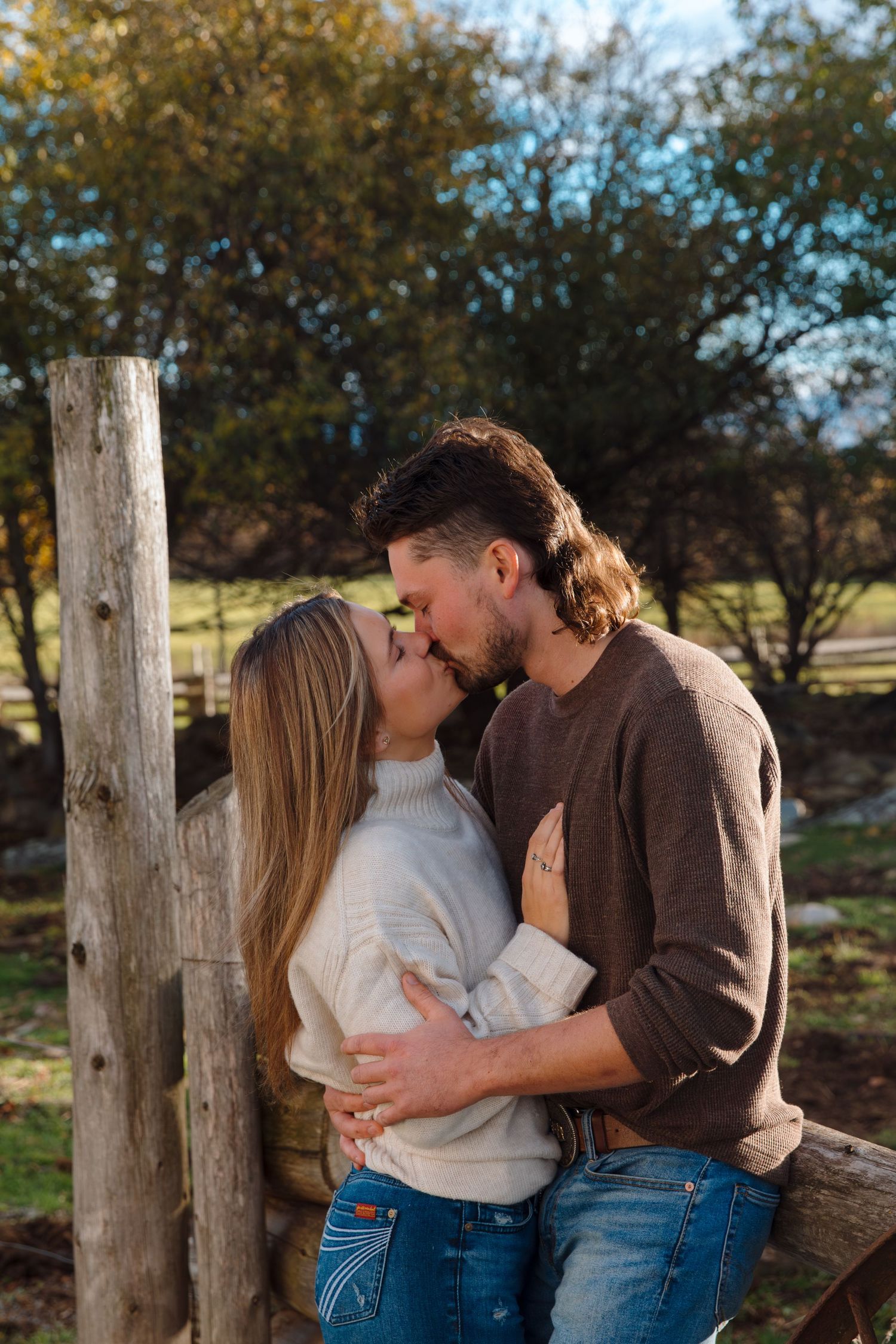 Intimate couple's portrait session in a rustic outdoor setting with fall colors.
