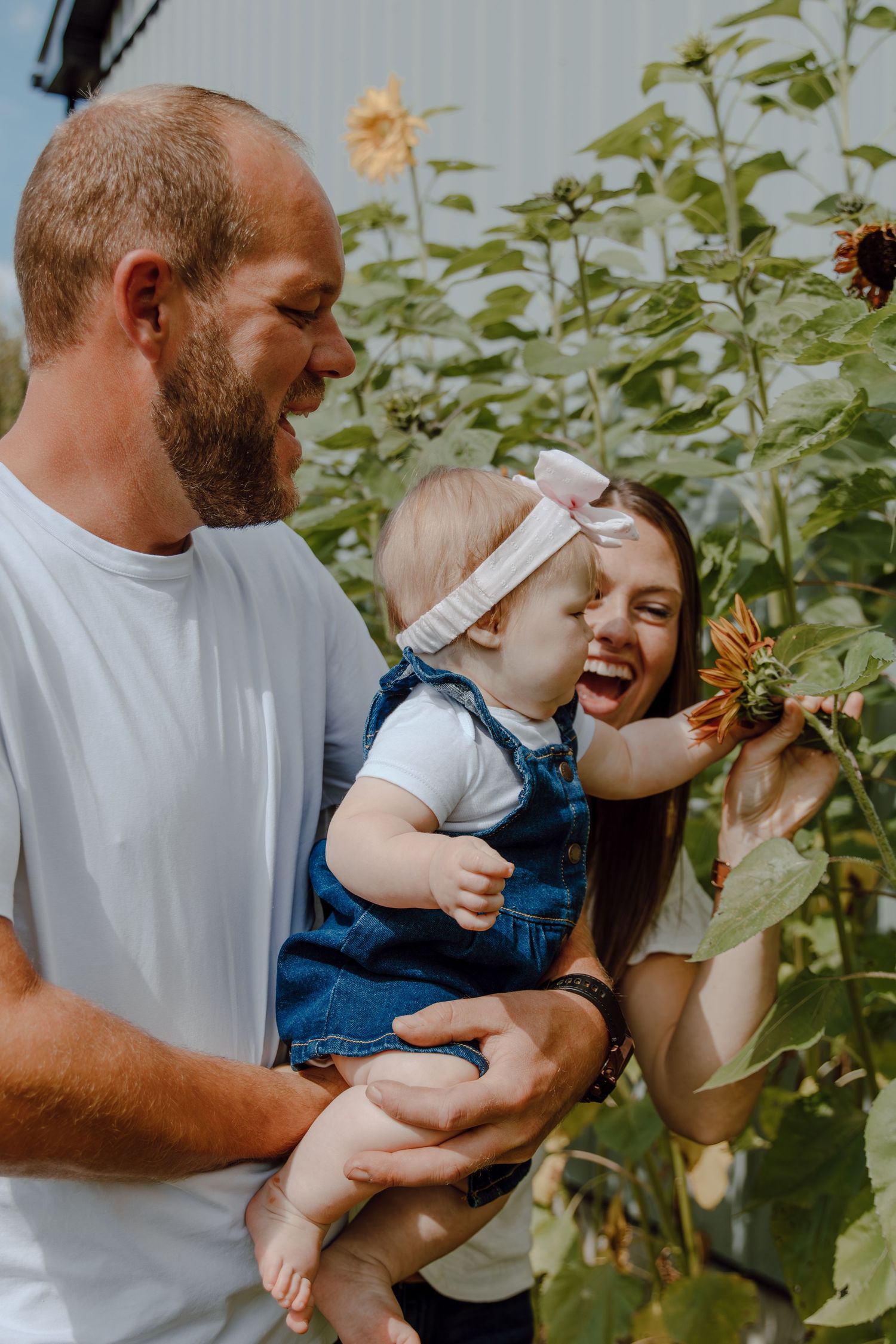 A cheerful family moment captured in a sunflower garden.
