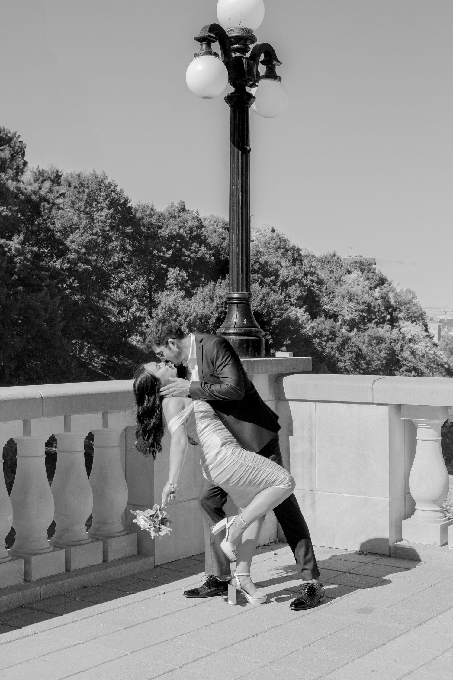 Sequence showing a couple dancing and dipping on a stone balcony.
