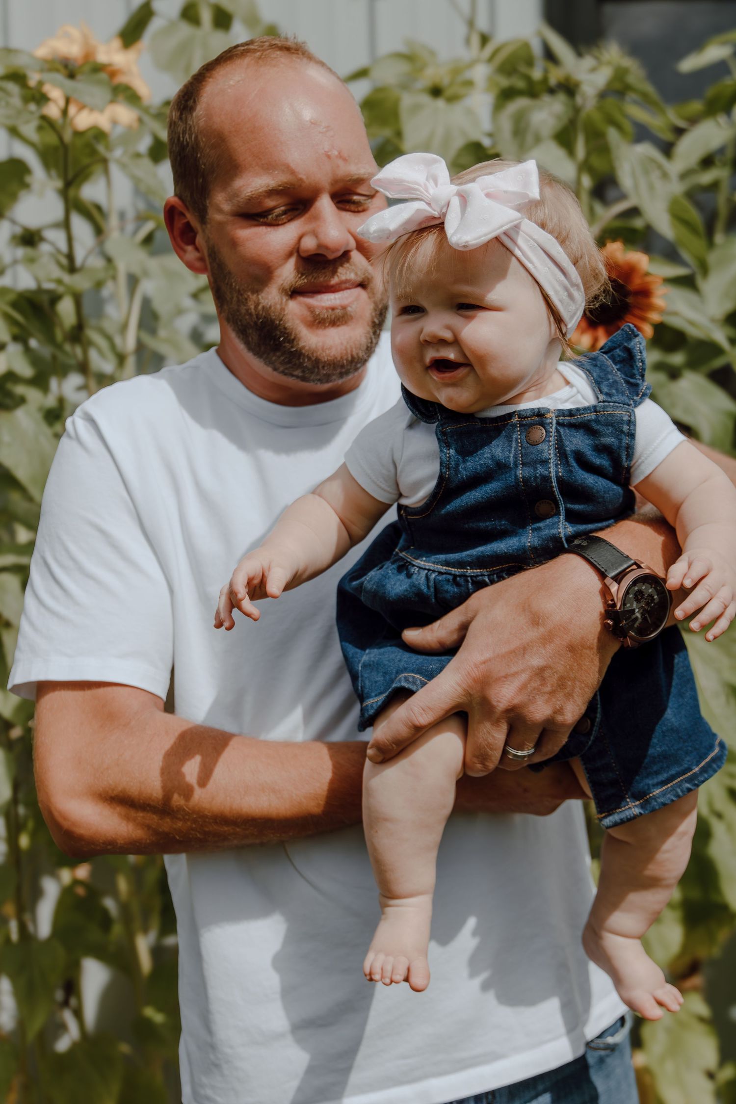 A sweet outdoor portrait in a sunflower garden on a sunny day.