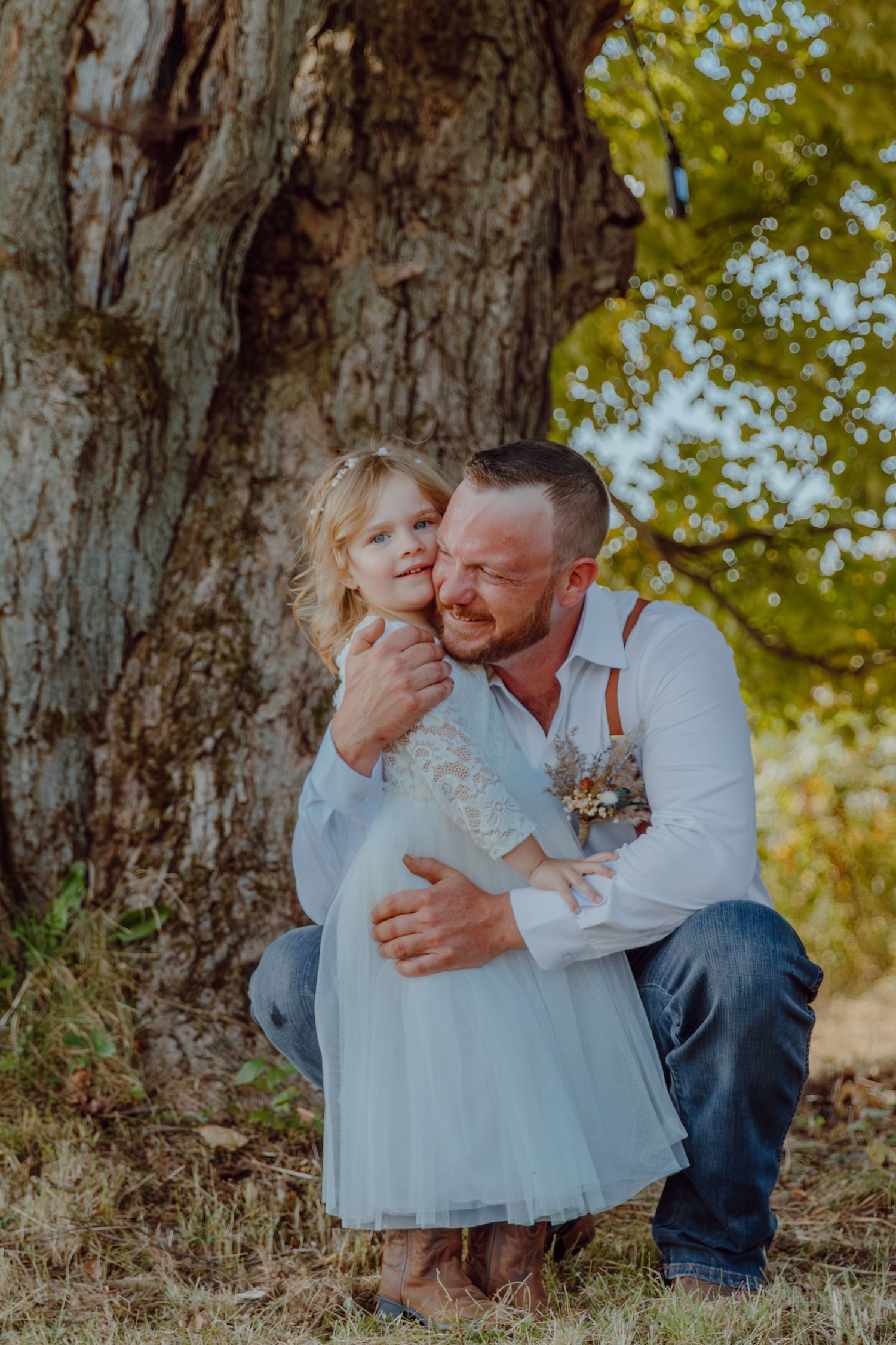 Sweet candid family portraits taken outdoors against a natural backdrop with autumn trees.