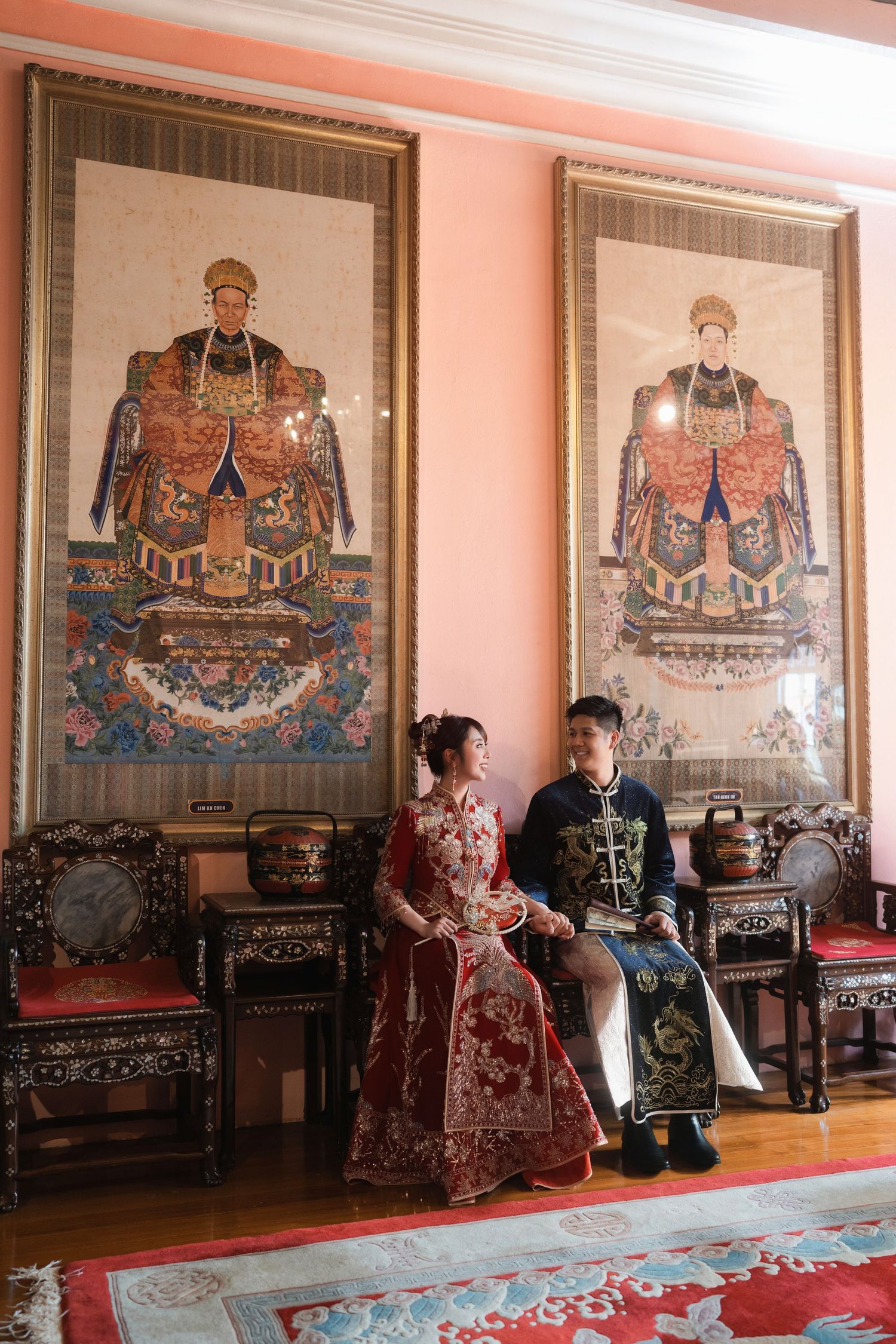 Bride and groom wearing traditional Peranakan wedding outfits in a heritage home for Peranakan wedding inspiration