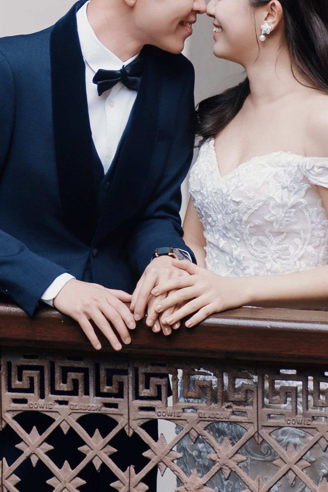 Close-up of a couple lean at the staircase at Seven Terraces