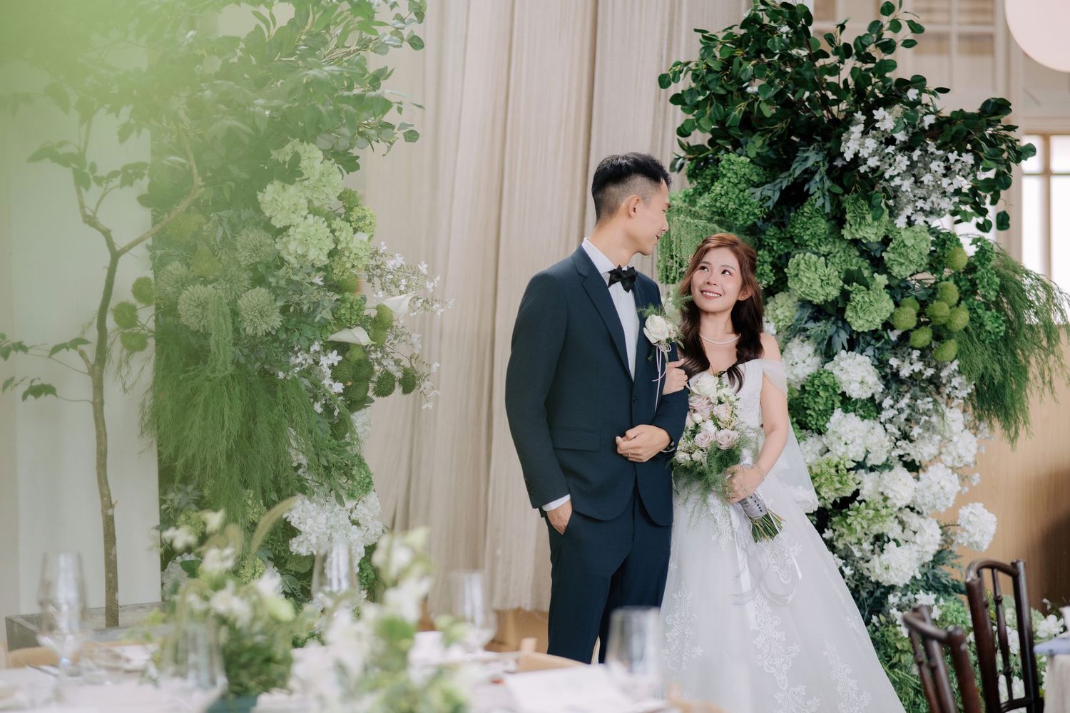 Elegant Peninsula House Penang wedding reception featuring tall green and white floral pillars