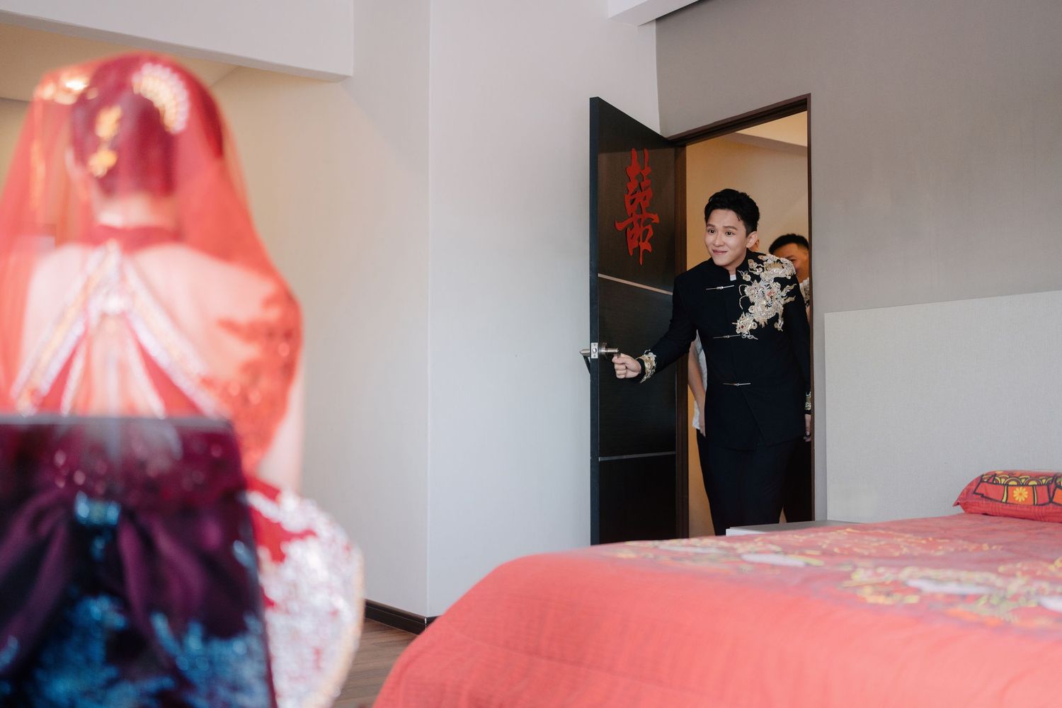 Groom smiles during a traditional Chinese wedding gate crashing entrance