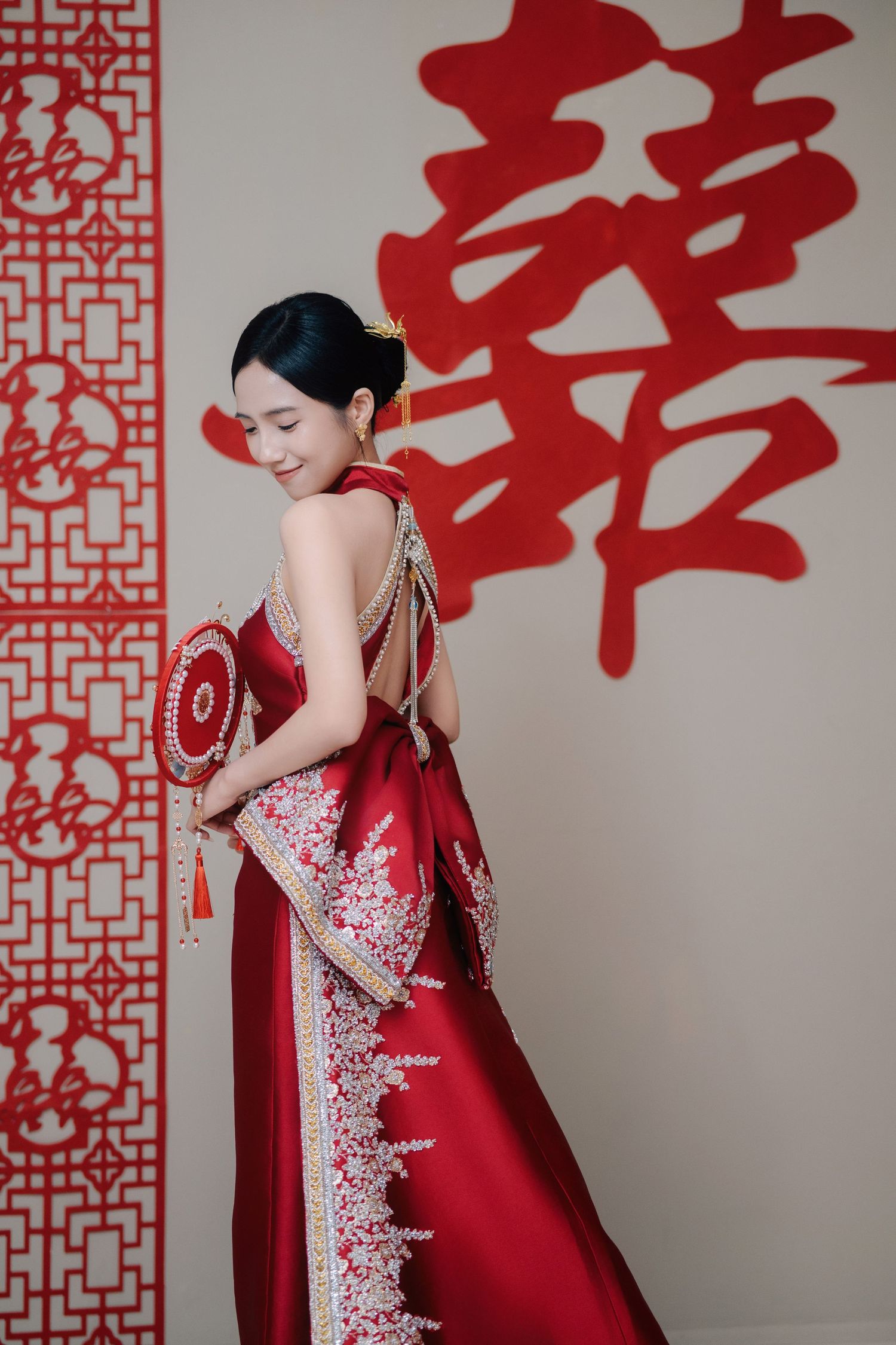 Detailed embroidery on a modern red wedding Kua worn at a Traditional Chinese Wedding
