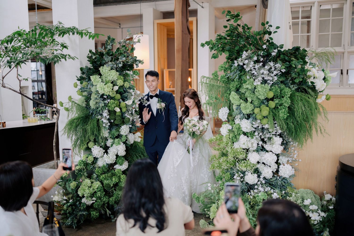 Wedding entrance at Peninsula House Penang venue with modern floral installations and industrial architecture