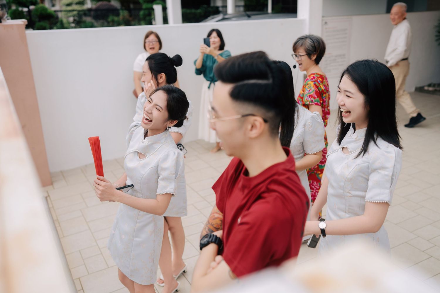 Laughing bridesmaids waiting to start traditional Chinese wedding gate-crashing games