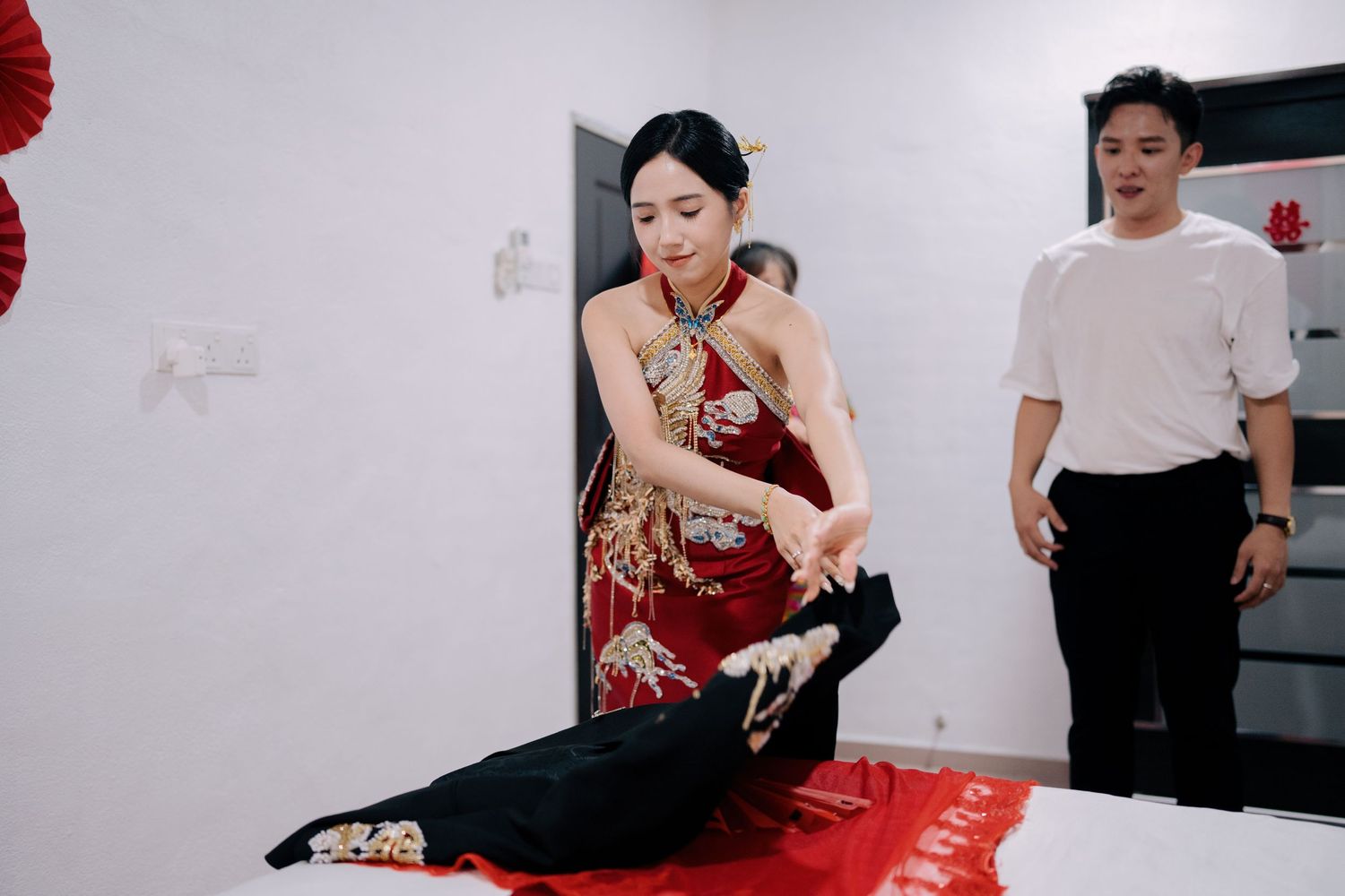 Bride performing the bed-setting ritual (An Chuang) for a traditional Chinese wedding
