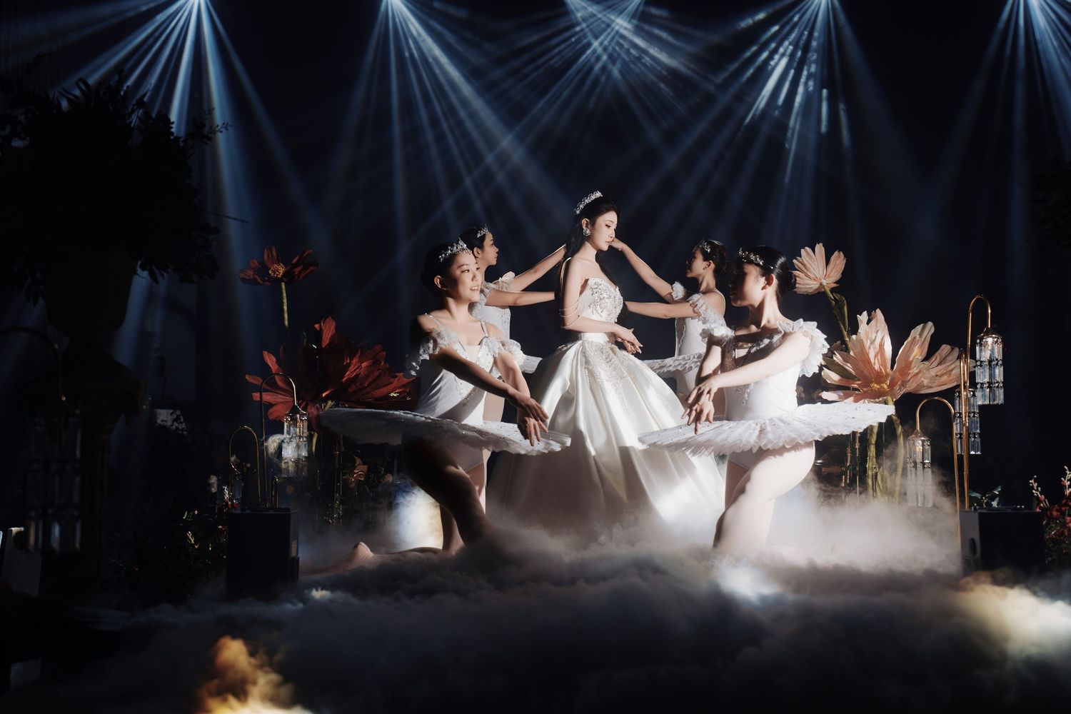 Bride surrounded by ballet dancers on a foggy stage for a theatrical wedding performance