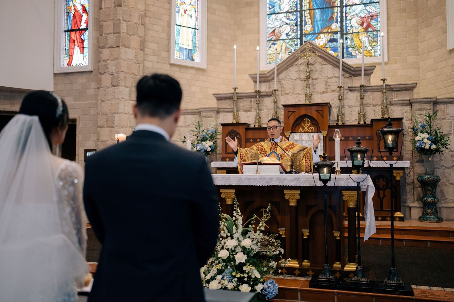 Catholic priest performing the Liturgy of the Eucharist at a traditional wedding mass