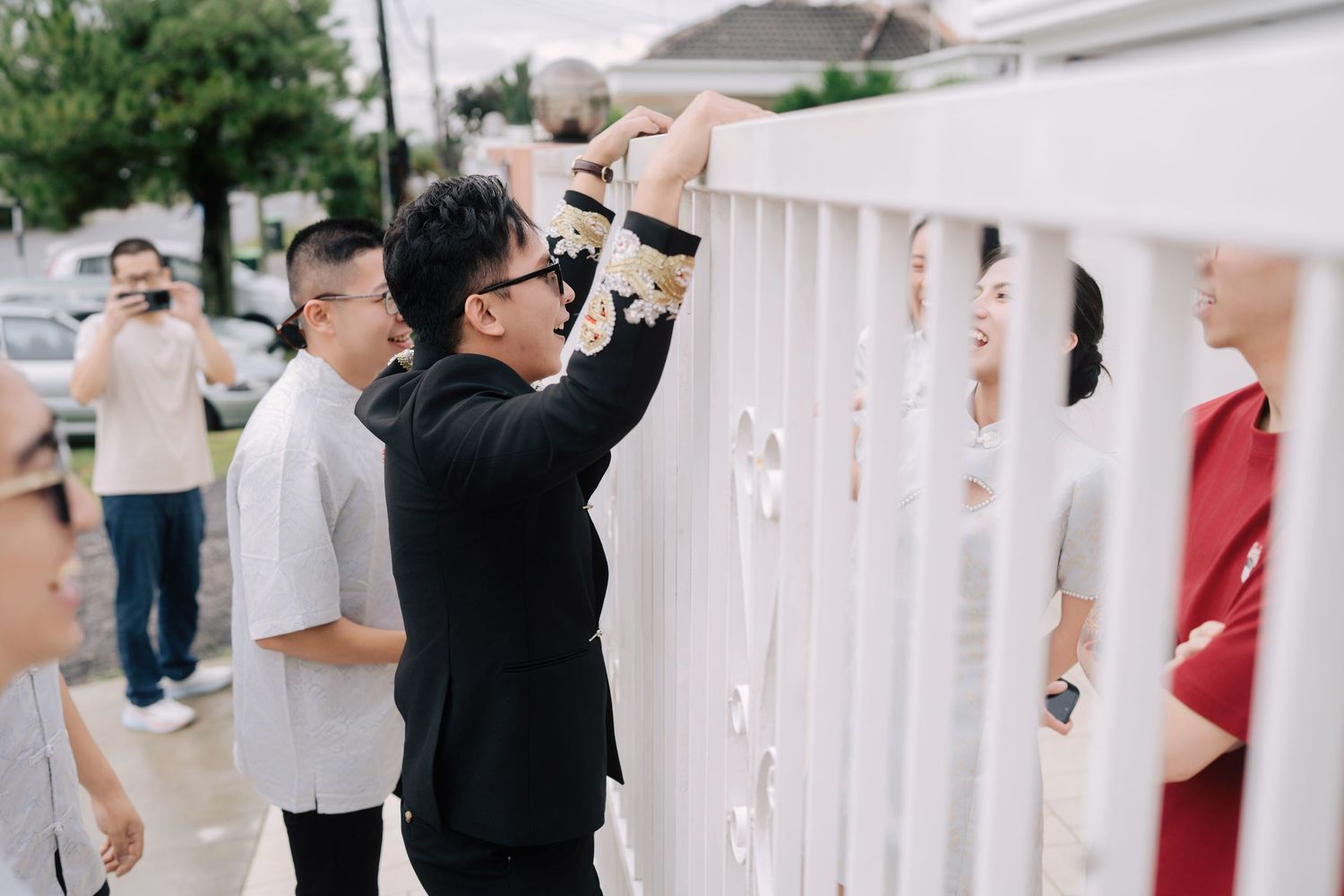 Groom negotiating entry during traditional Chinese wedding gate-crashing games at the bride's house