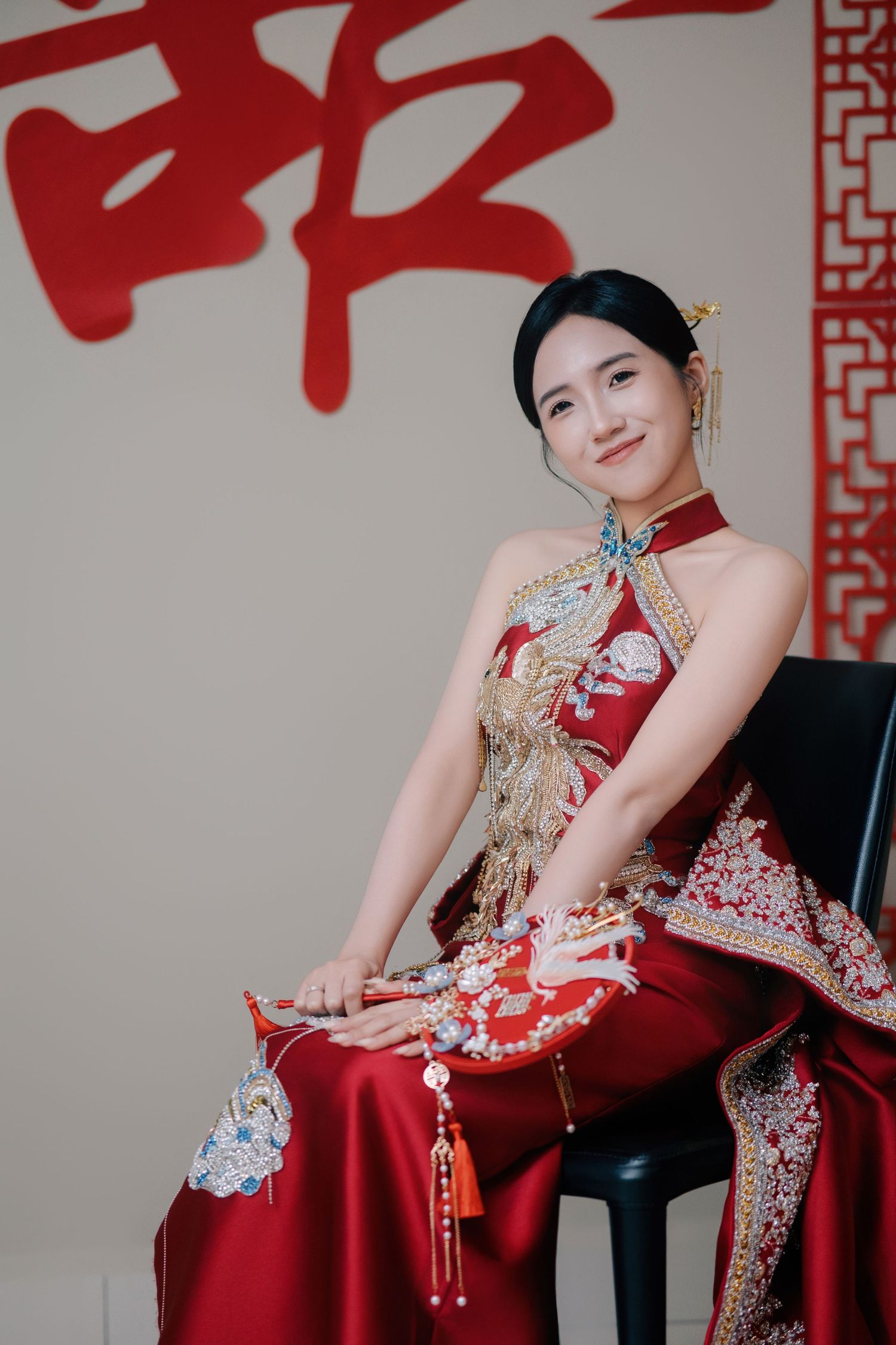 Traditional Chinese Wedding bride in a phoenix-embroidered red gown for the tea ceremony