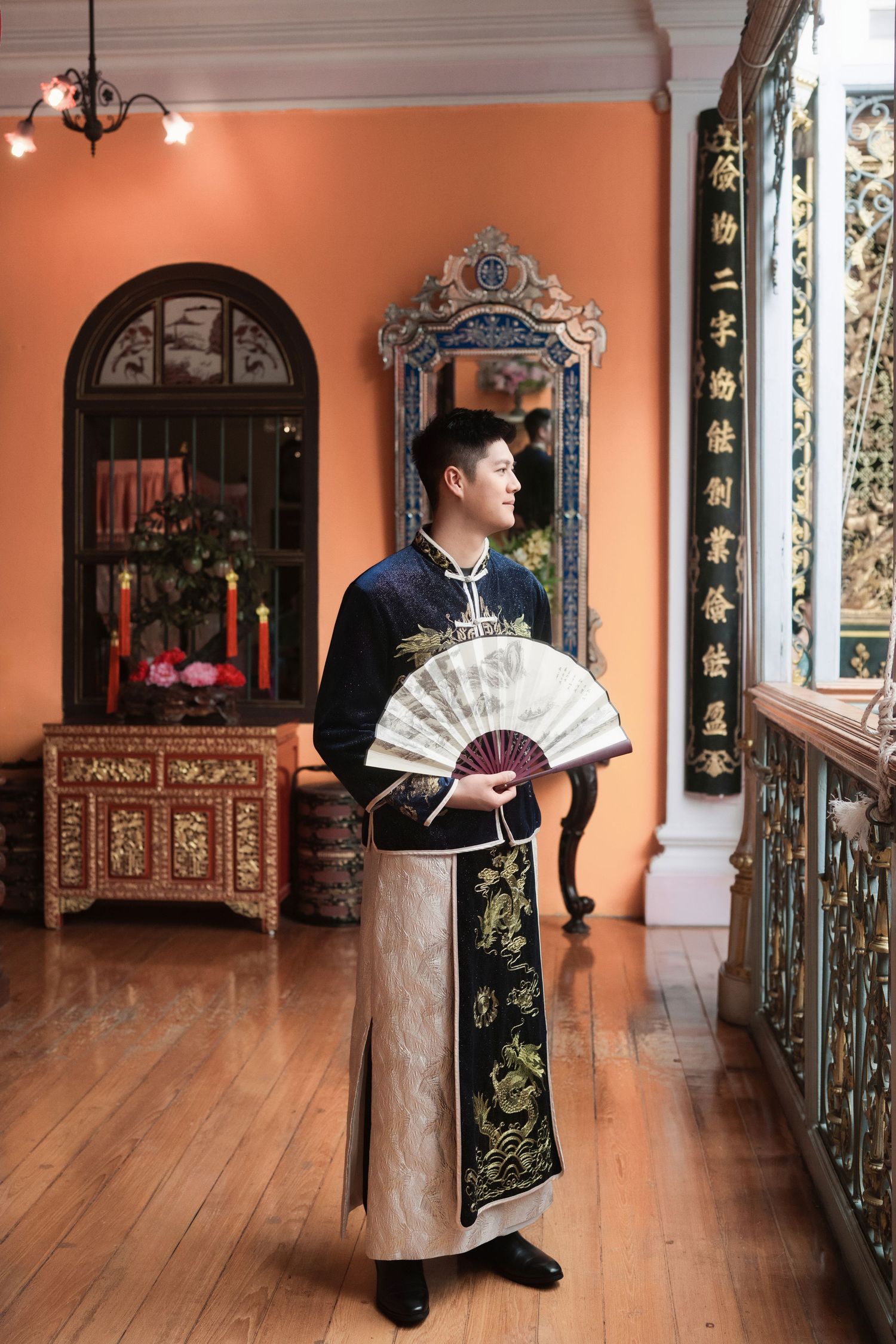 Groom wearing a modern navy embroidered Changshan for a traditional Chinese wedding ceremony