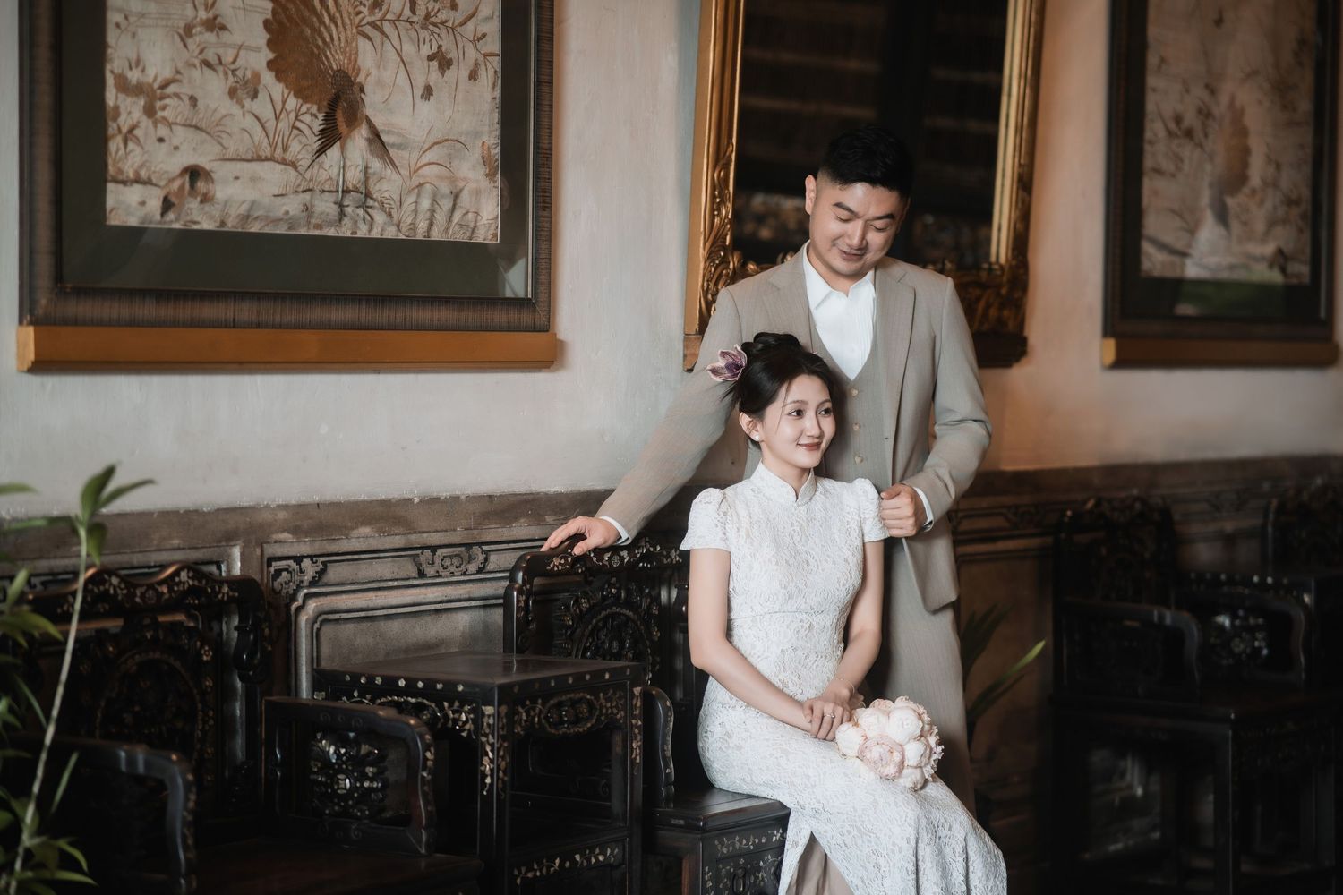 Couple on antique furniture at Blue Mansion Penang, highlighting the mansion's rich interior design