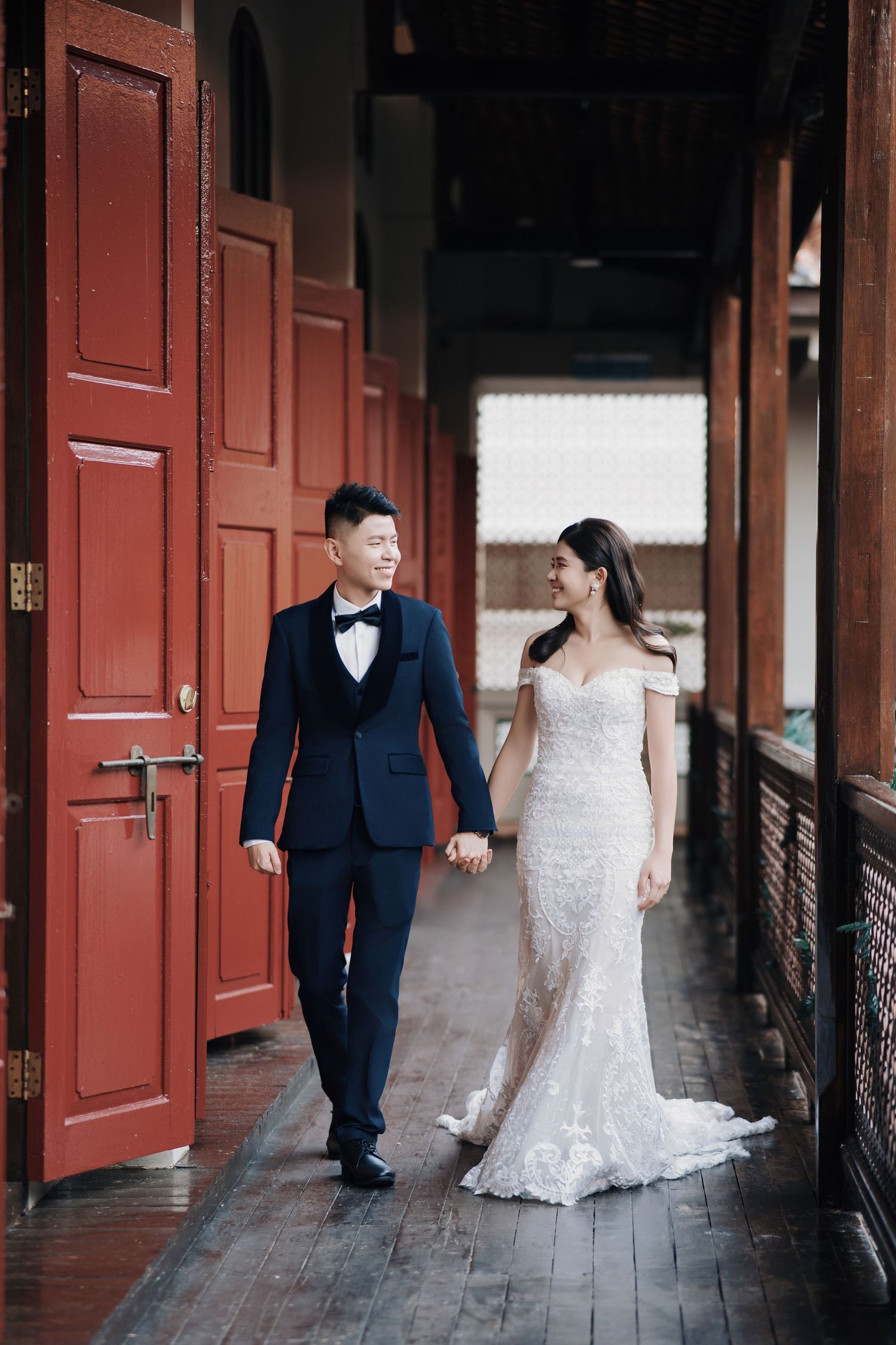 Bride and groom at their destination wedding George Town Penang, walking along the historic Seven Terraces balcony