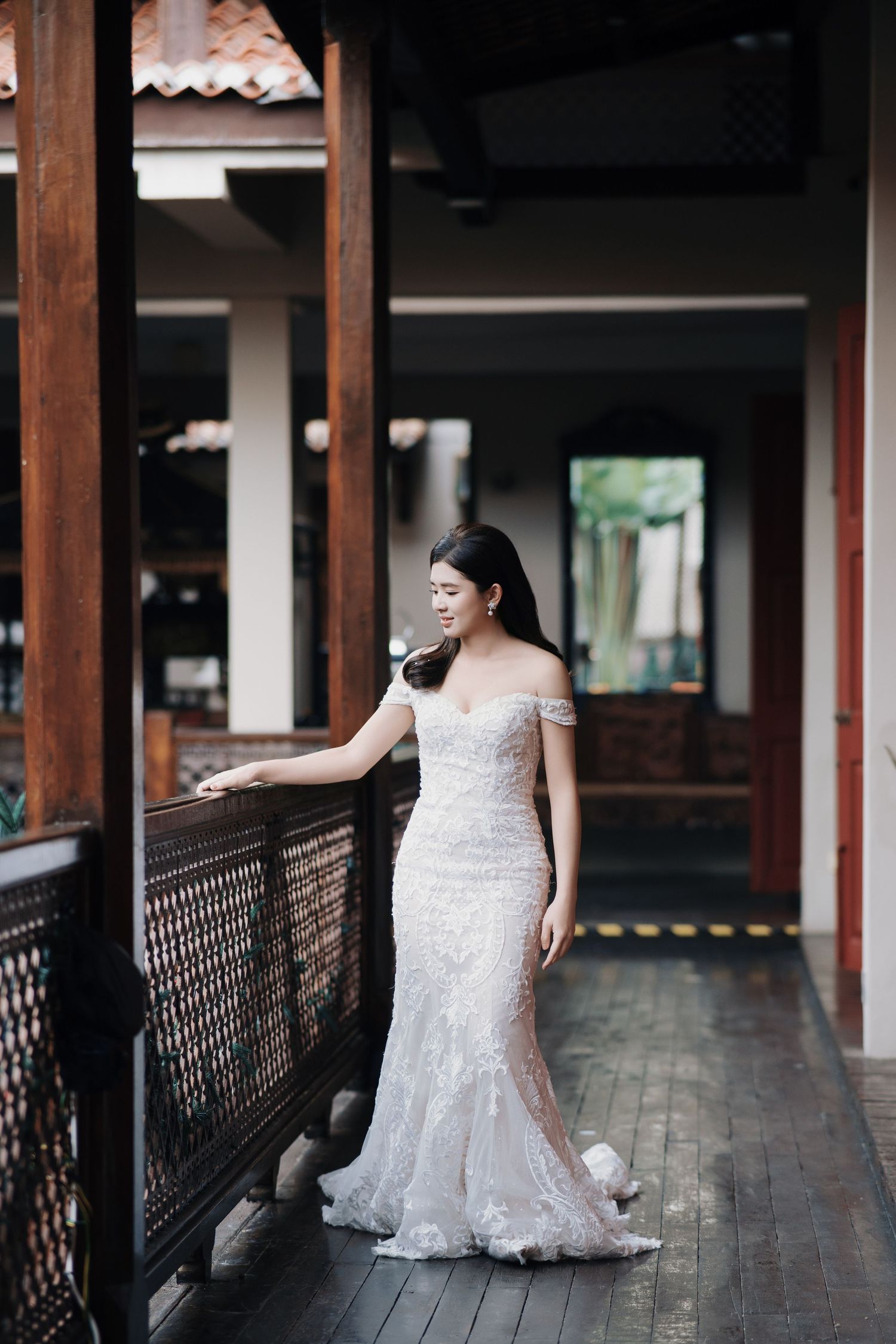 Bride in an off-the-shoulder lace dress at Seven Terraces, a heritage hotel wedding Penang venue with wood beams