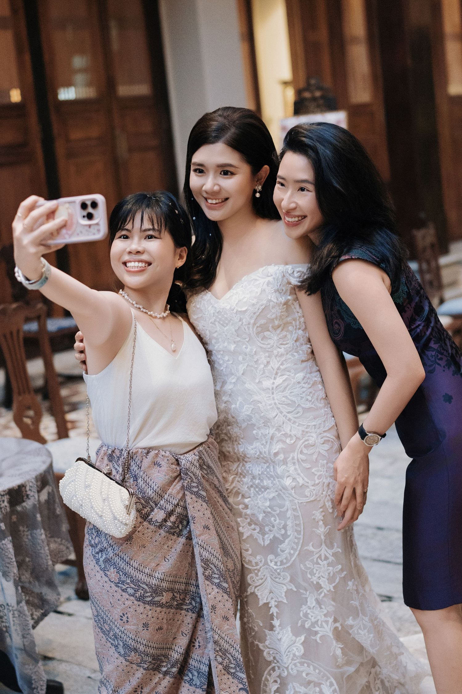 Guests and bride taking a selfie at a Seven Terraces Penang wedding reception