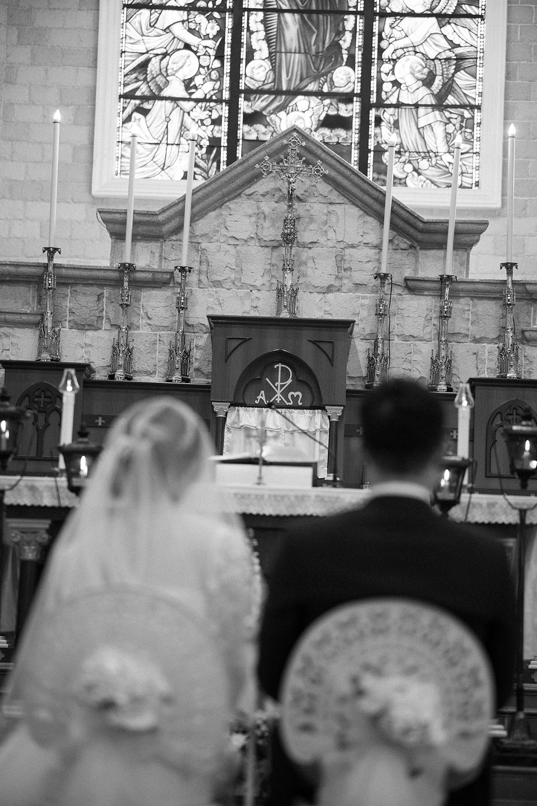 Artistic black and white view of a bride and groom during their church wedding ceremony
