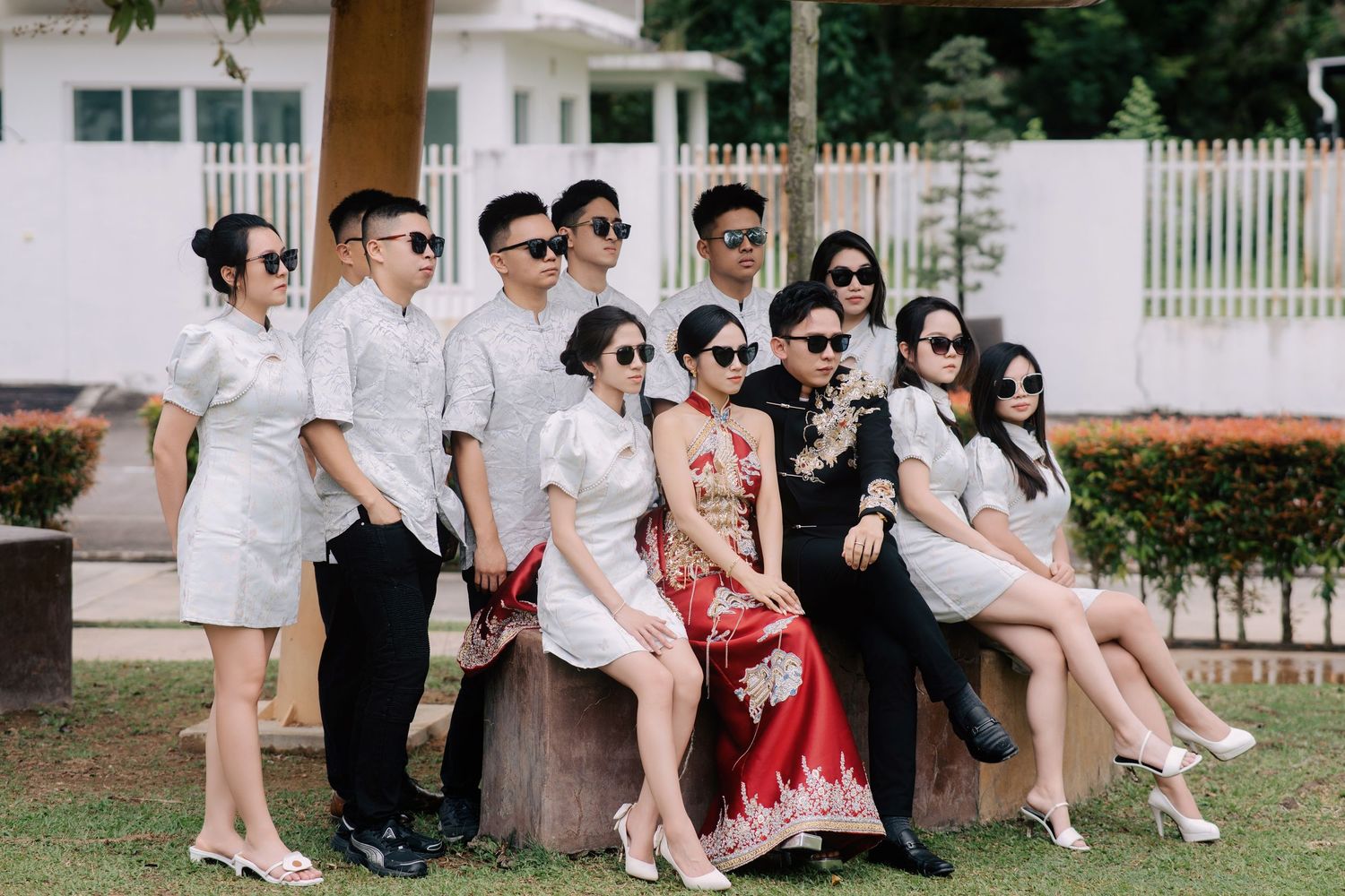 Modern traditional Chinese wedding party with bridesmaids and groomsmen wearing stylized Chinese wedding attire and sunglasses