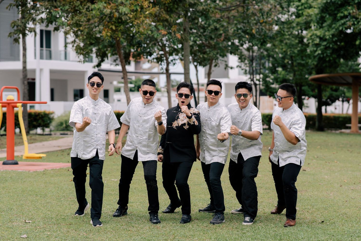 Groom and groomsmen in traditional Chinese wedding shirts posing