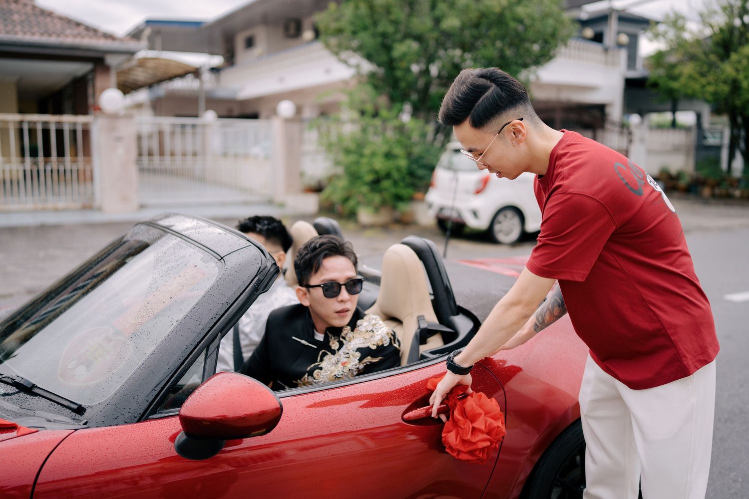 The groom is greeted at the bridal car, a traditional custom in Penang Chinese wedding celebrations