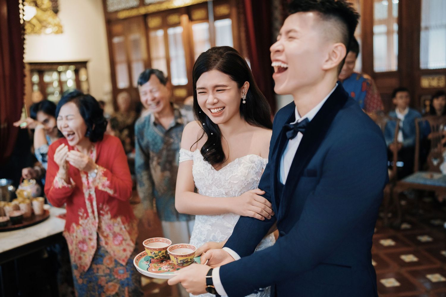 Couple sharing a laugh during their traditional tea ceremony at Seven Terraces Penang