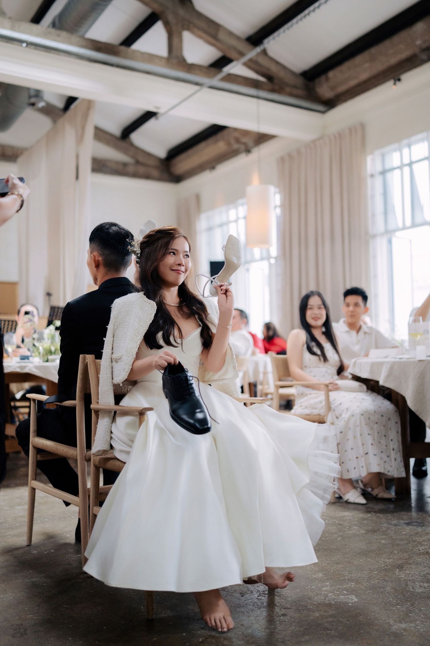 Bride laughing while playing the wedding shoe game at Peninsula House Penang