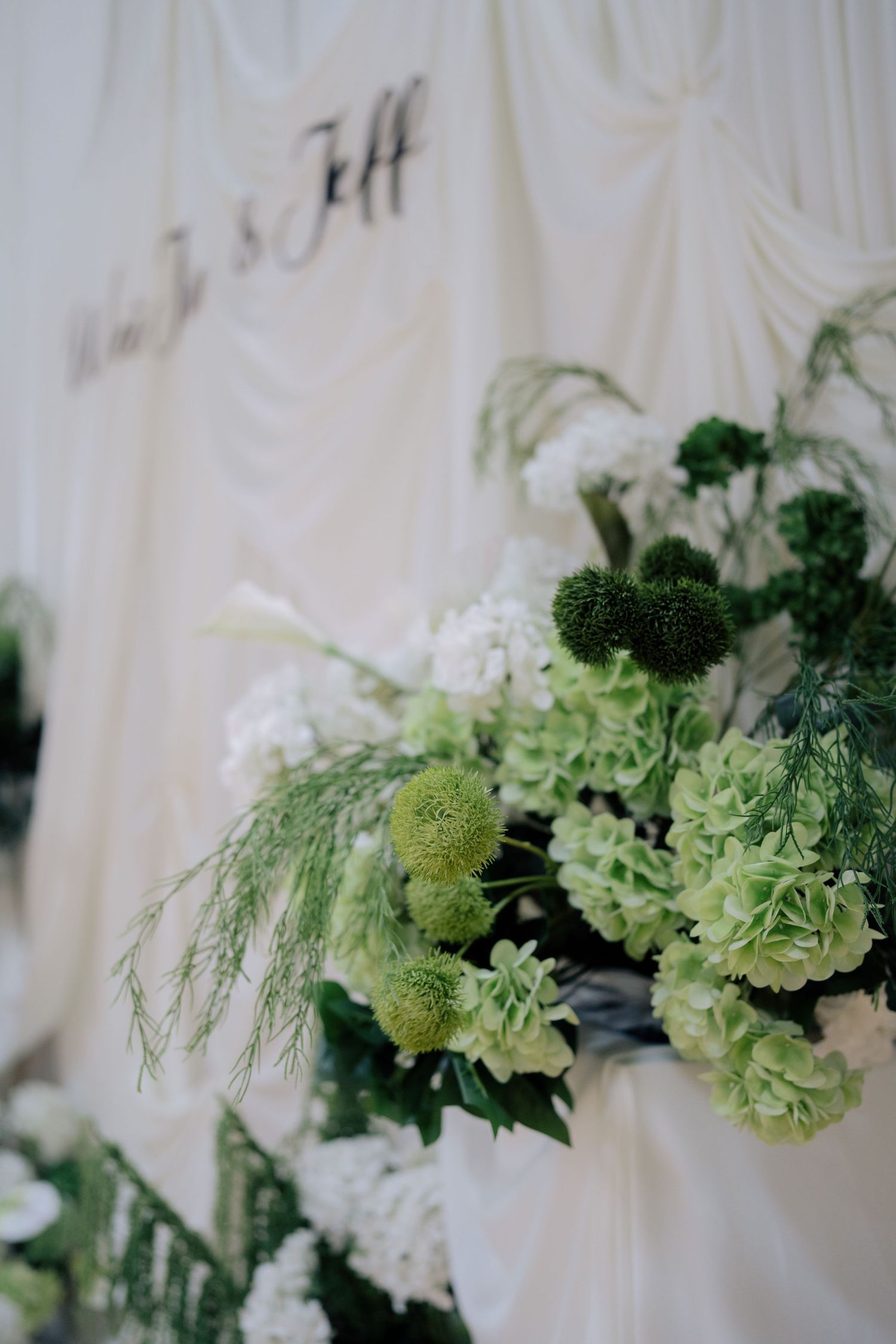 Lush botanical wedding flowers featuring green pom-poms and white hydrangeas at Peninsula House Penang