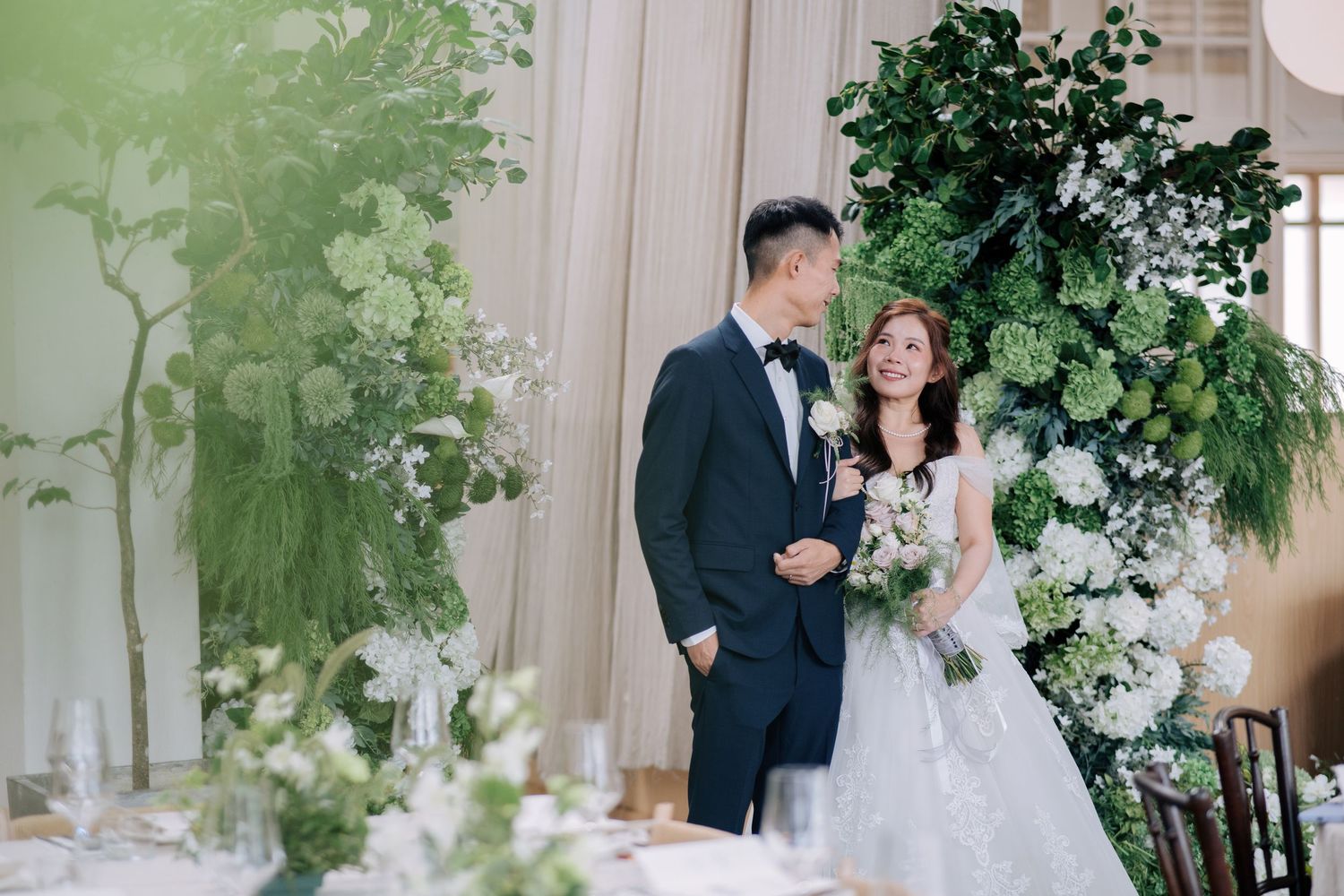 Wedding ceremony space decorated with lush white flowers and green foliage at Peninsula House in Penang