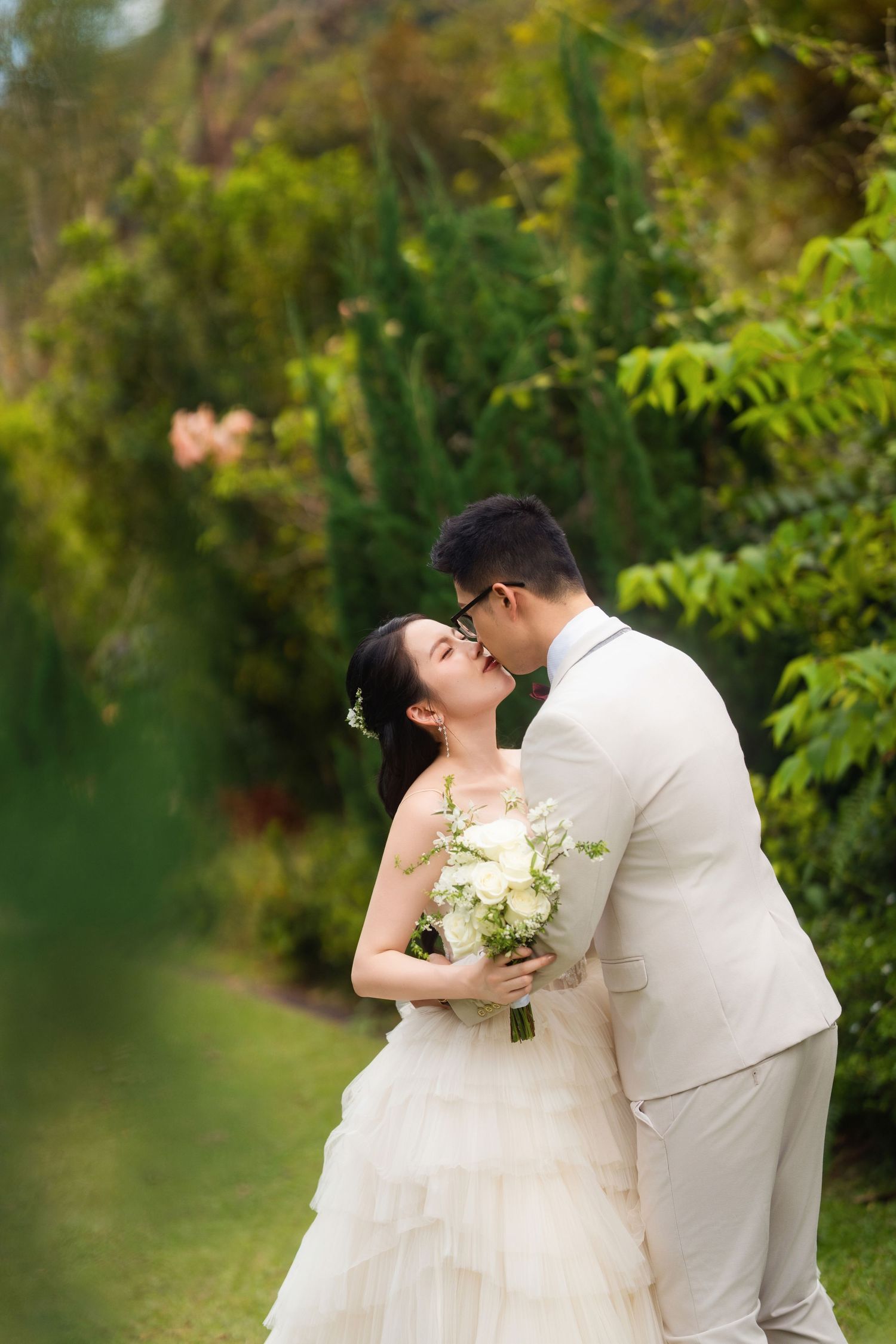 Romantic garden wedding photos with lush greenery and natural lighting.
