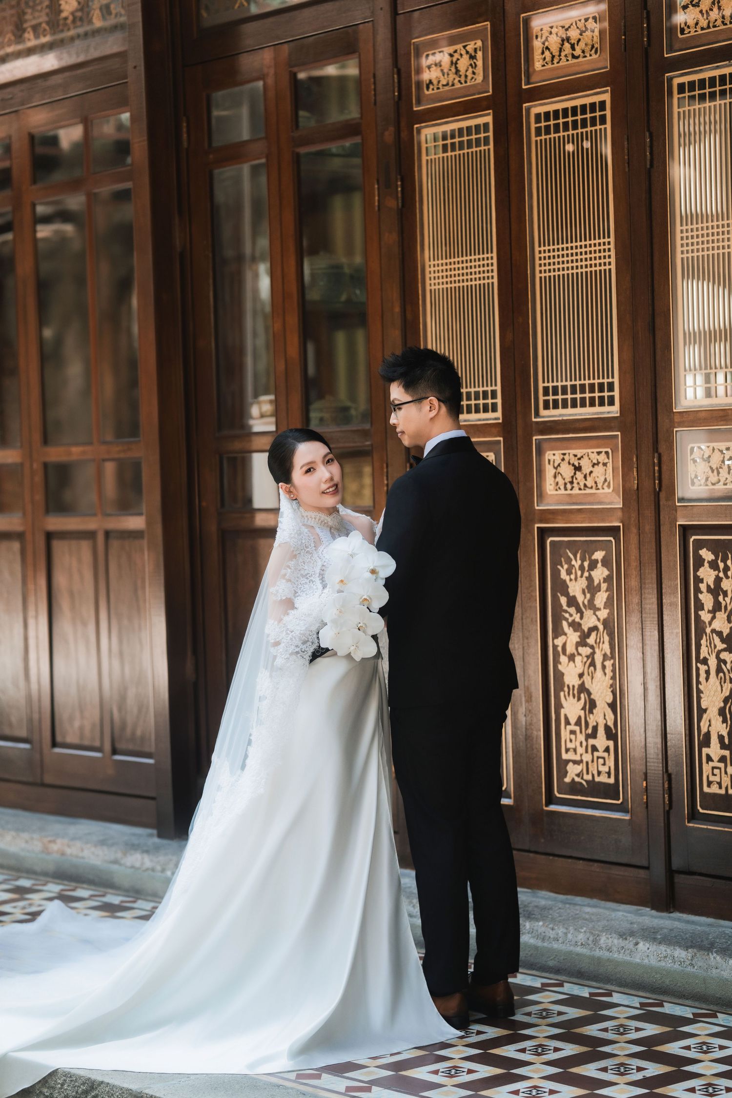 Wedding photo sequence showing couple against ornate wooden panels in traditional Asian building.