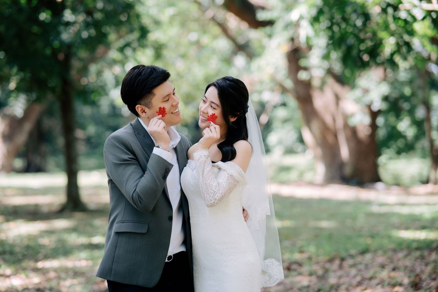 Romantic wedding photoshoot in a lush green park setting.