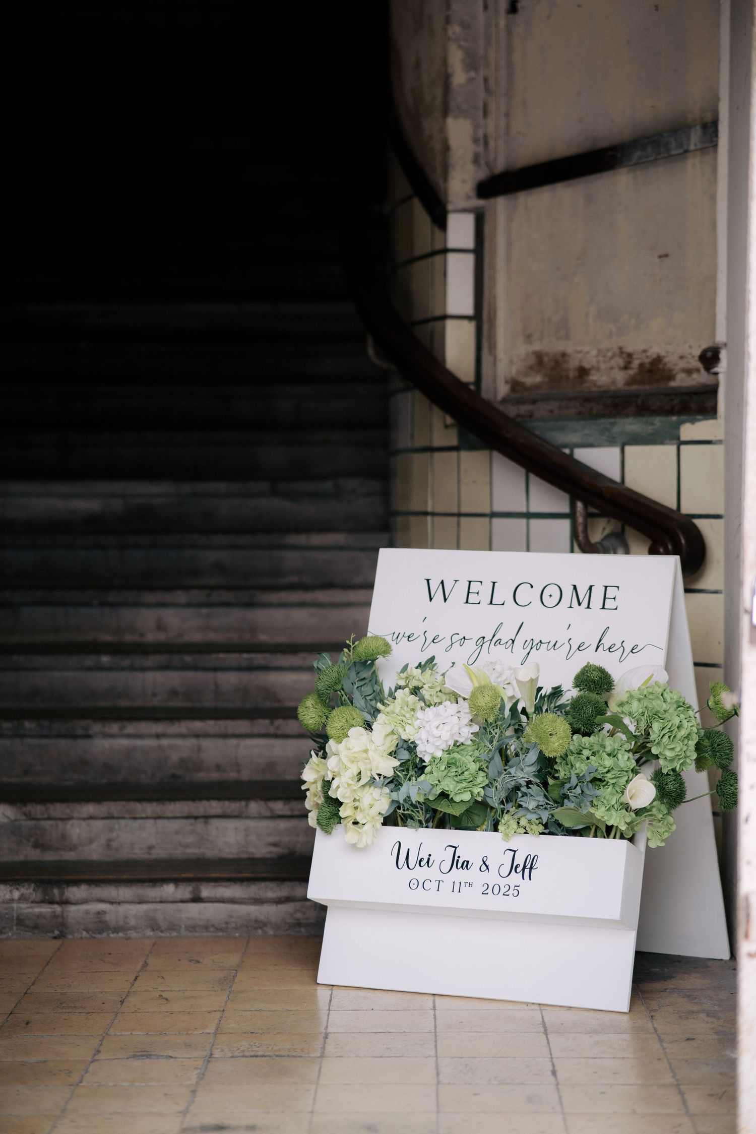 Floral wedding welcome board with green blooms at the Peninsula House entrance in Penang