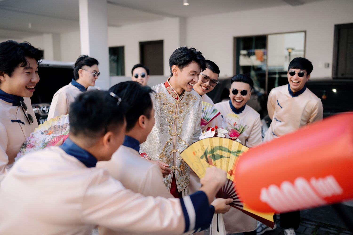 Wedding party members participate in traditional door games and celebrations.