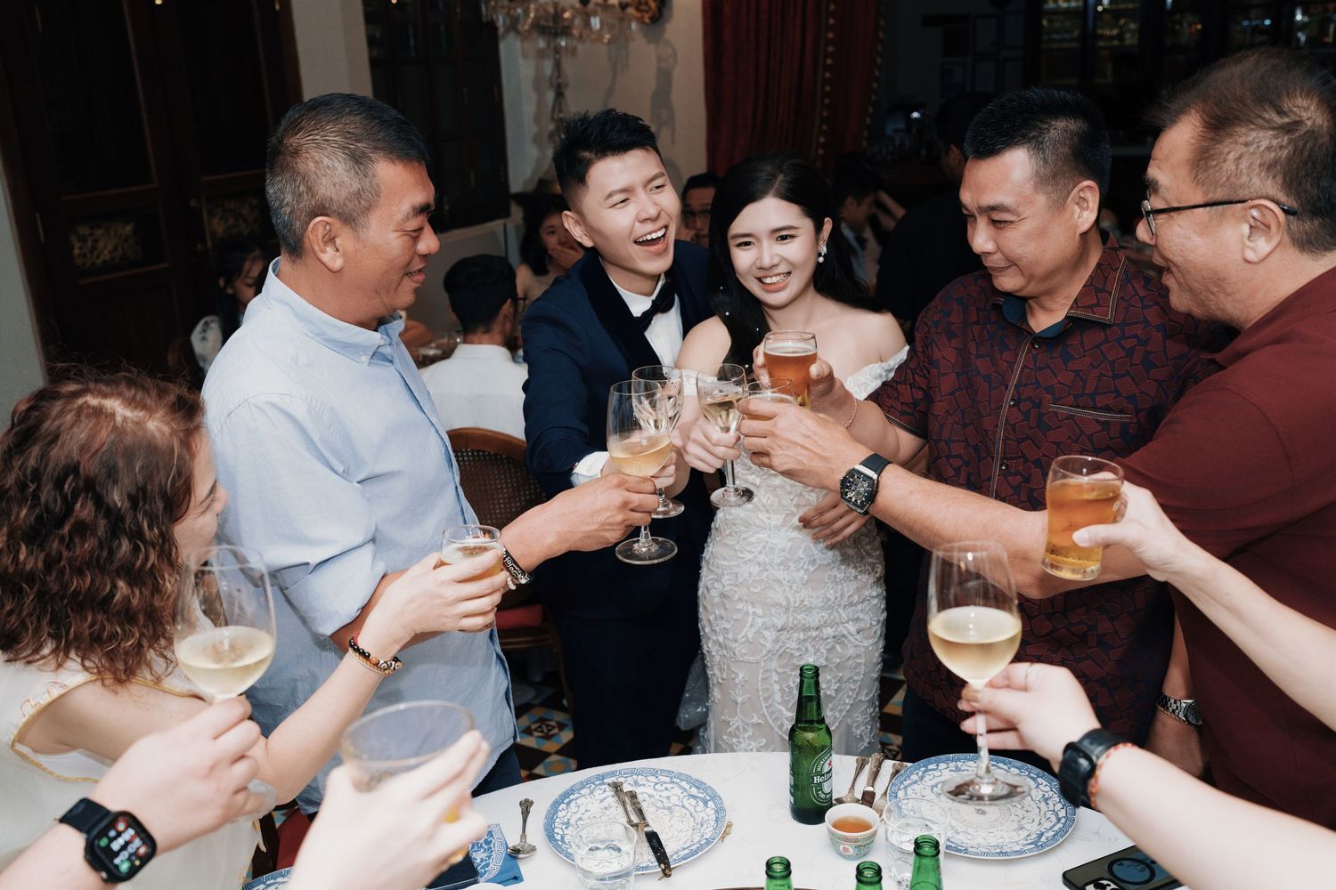 Wedding couple toasting with family at a Kebaya Dining Room, Seven Terraces Penang heritage hotel reception