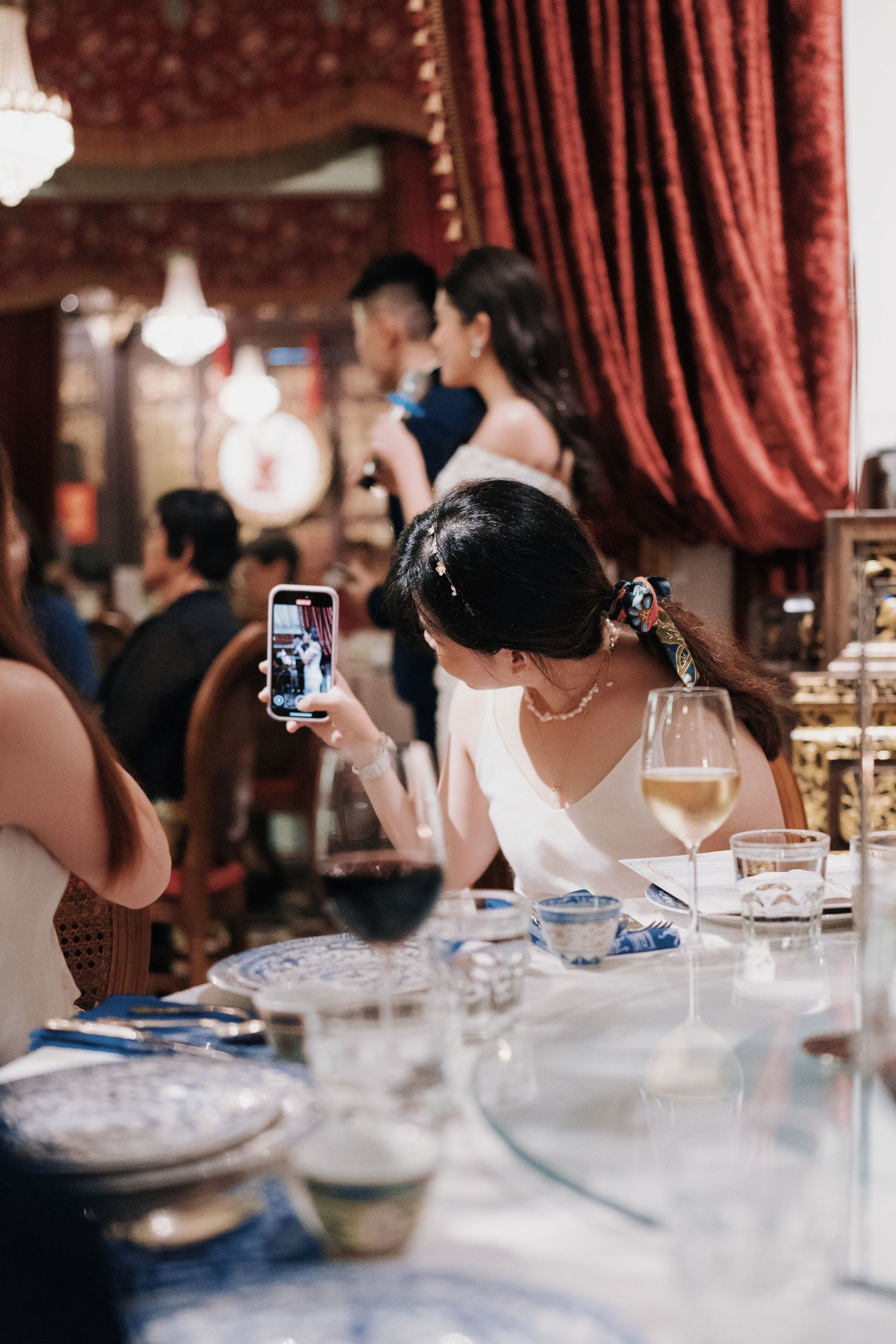 Wedding guest taking a video of the couple at a Kebaya Dining Room, Seven Terraces Penang heritage dinner event