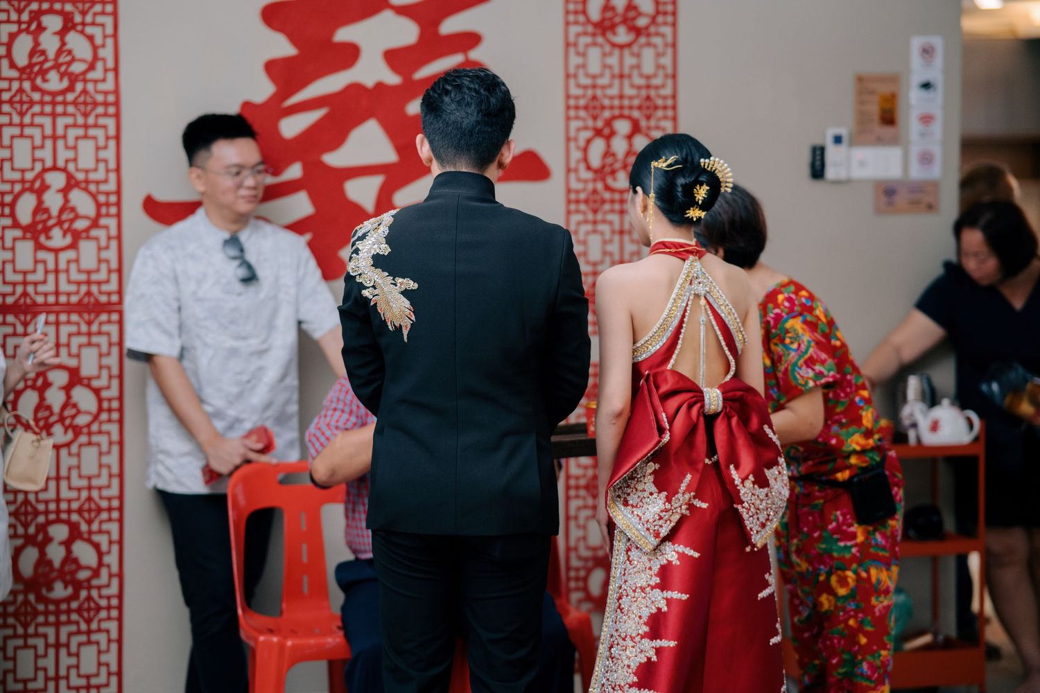 Back view of the bride and groom standing before a large 