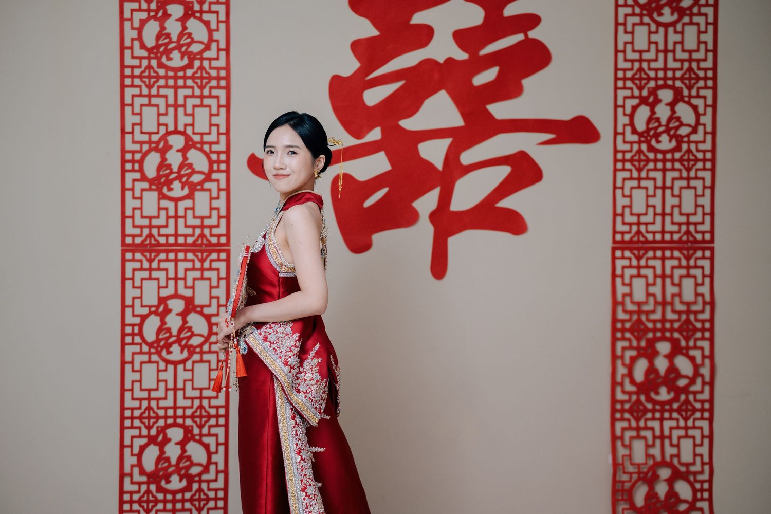 Side profile of a bride holding a ceremonial fan, capturing the essence of a Traditional Chinese Wedding in Penang
