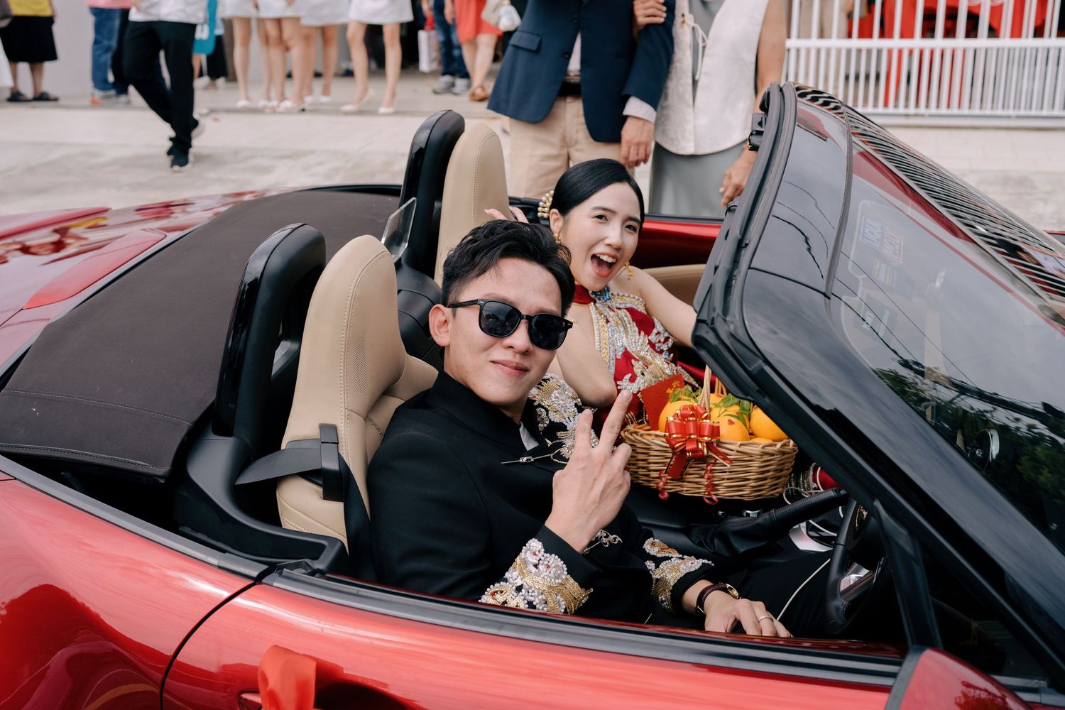 Happy couple in a red convertible during a Traditional Chinese Wedding in Penang bridal car procession
