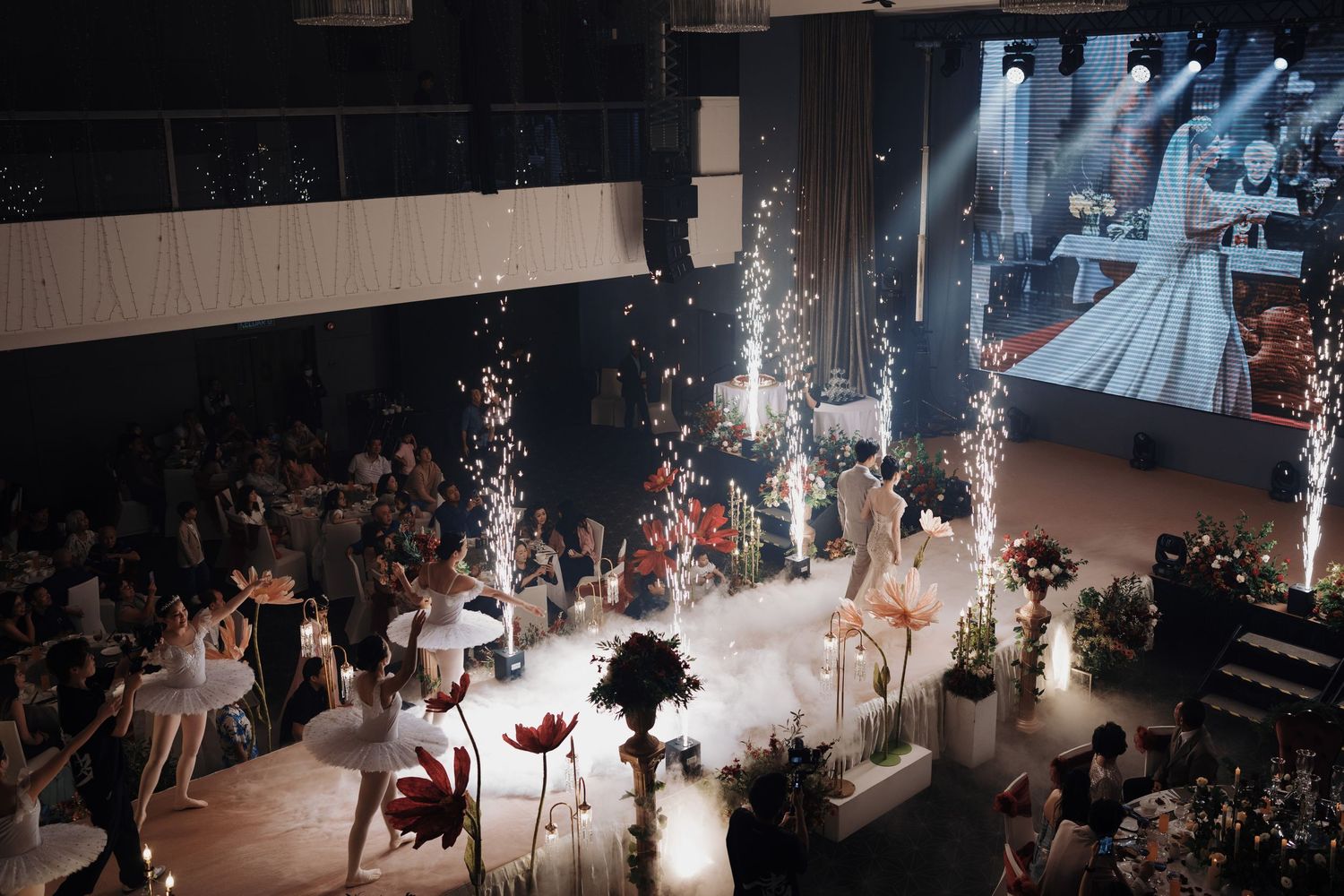 Luxury wedding reception walkway featuring ballerinas, fog effects, and indoor sparklers