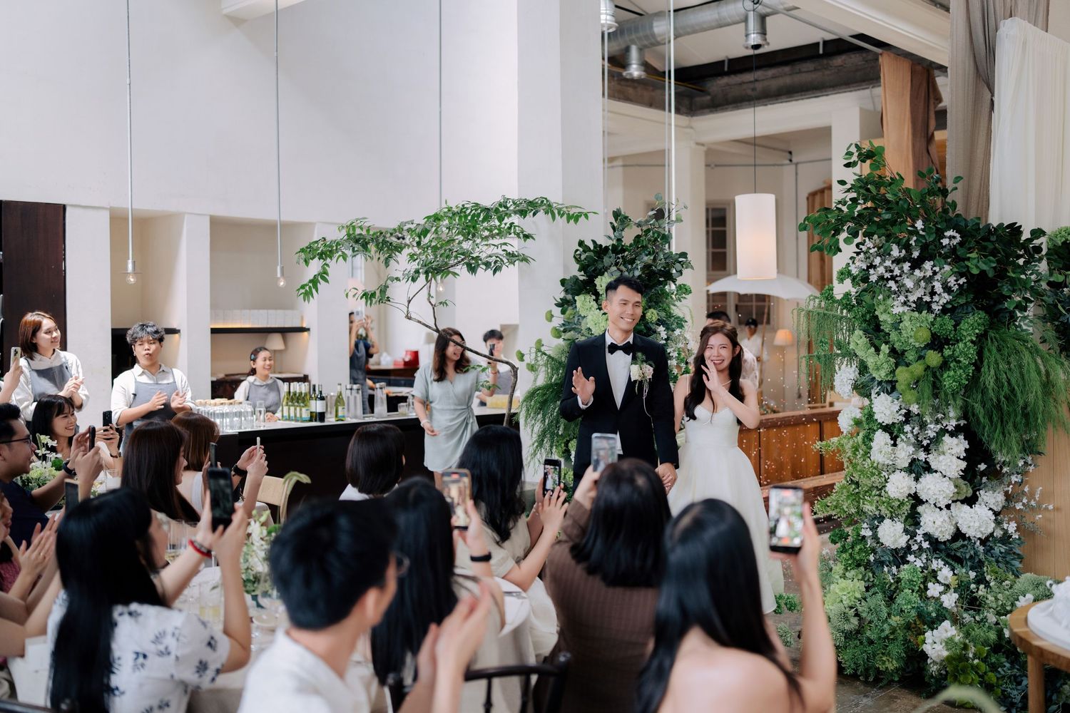 Wedding entrance at Peninsula House Penang featuring a smiling couple and lush floral decor