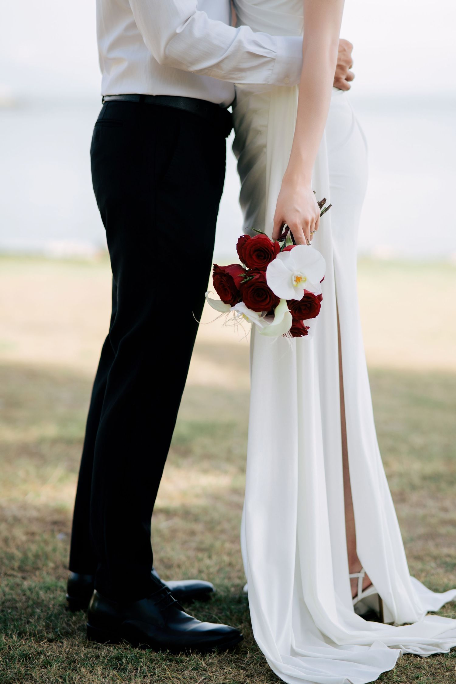 Detail shots of a wedding couple's formal attire and red rose bouquet.